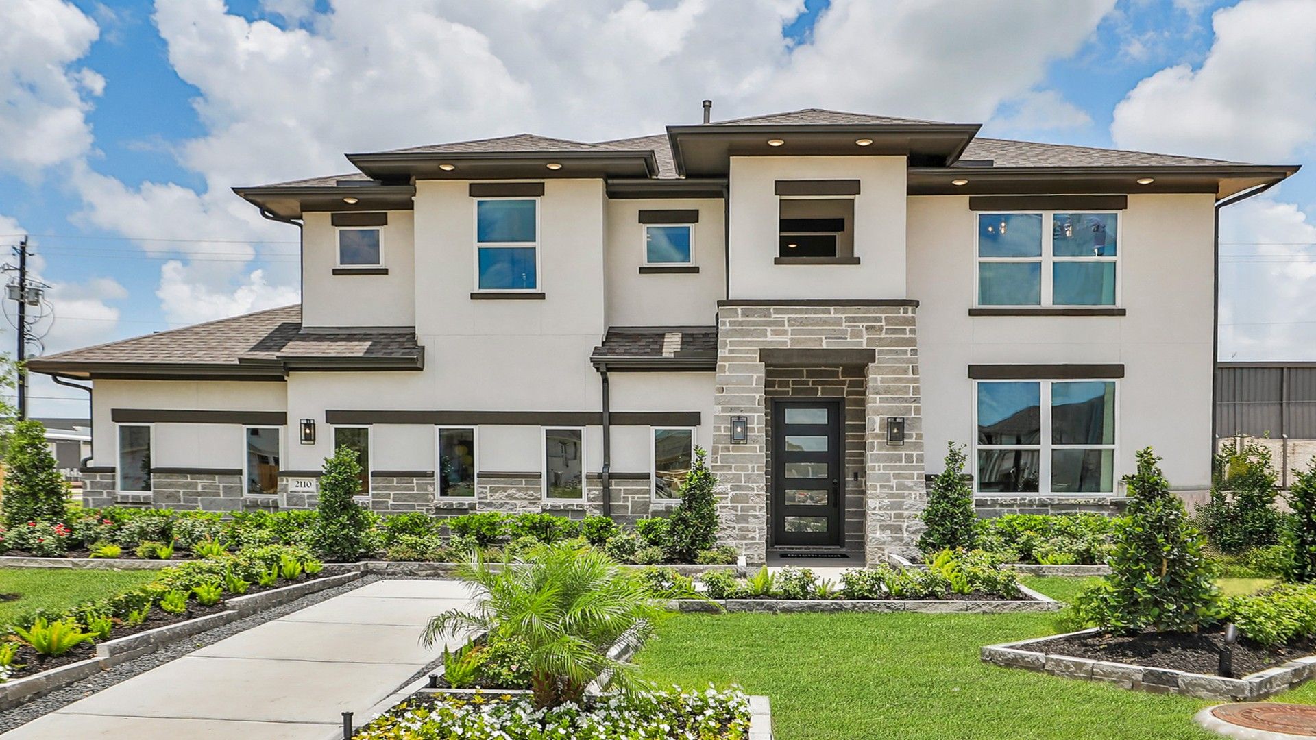Modern Two-Story Villa in Beamer Villas, Texas:Elegant stone facade and lush gardens enhance this Texas villa in Beamer Villas.