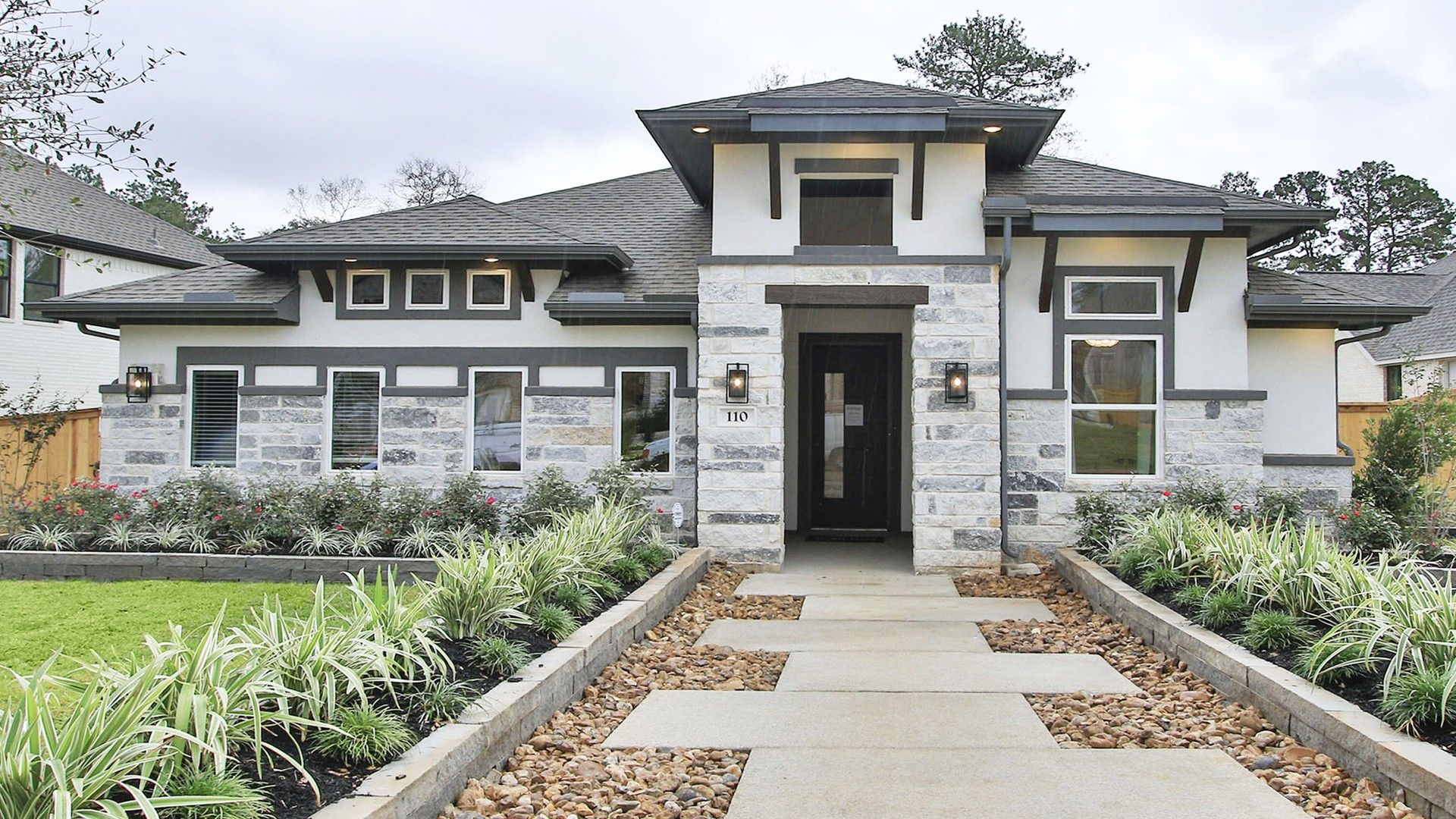 Modern Stone Facade Home in The Woodlands Hills Community:Exquisite stone facade with chic black accents, nestled in lush landscape. The Woodlands Hills.