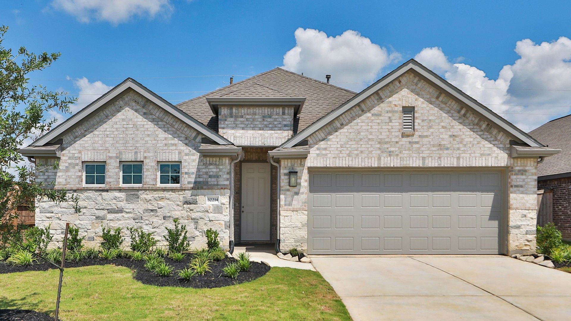 Modern Single-Story Home with Stone Facade in Oakwood Estates:Luxurious Oakwood Estates home boasts stone facade, gabled roof, and pristine landscaping.