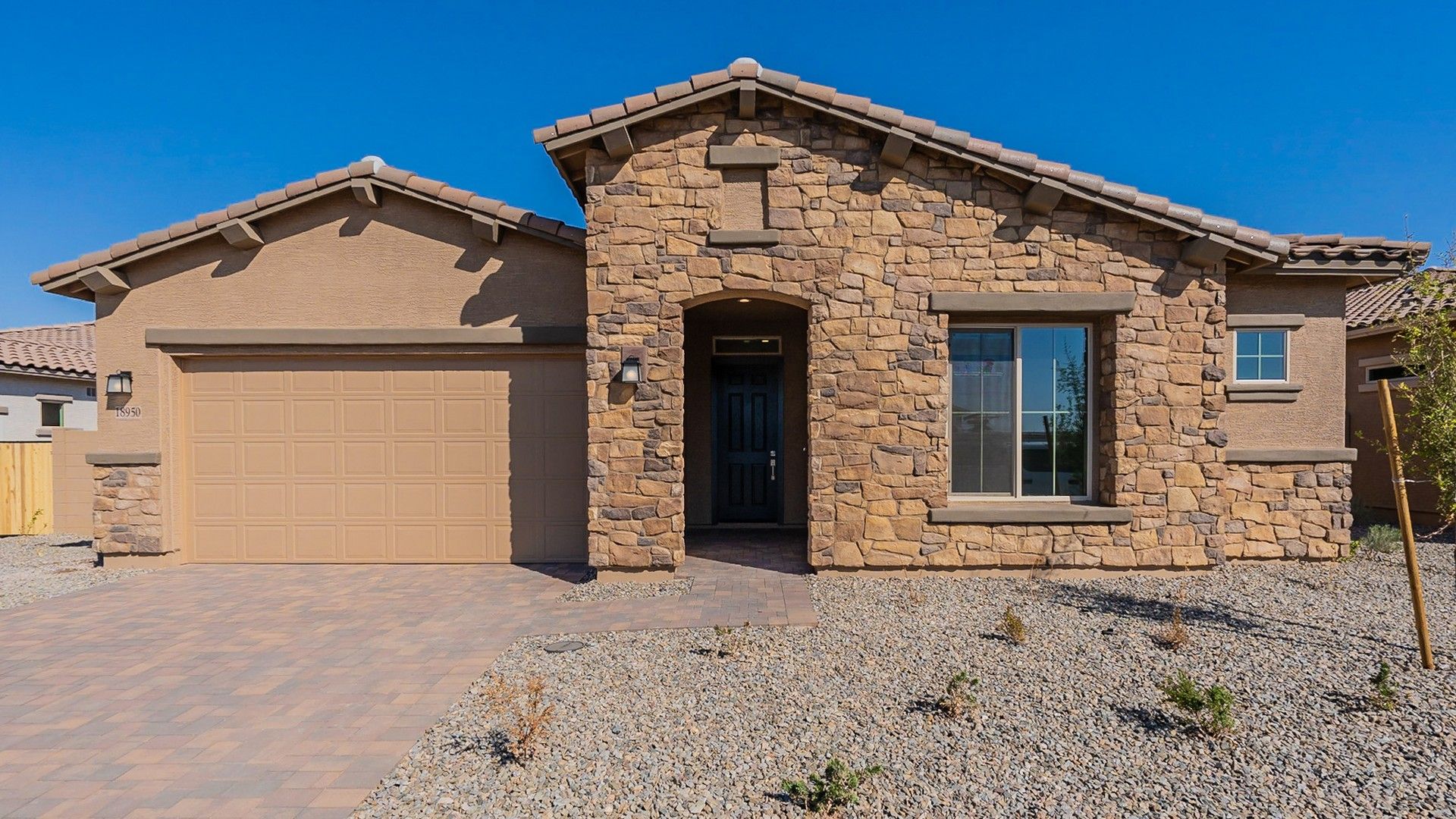 Luxurious Stone Facade House at Windrose Community:Exquisite stone facade with a sleek garage and elegant roofing, nestled in the prestigious Windrose community.