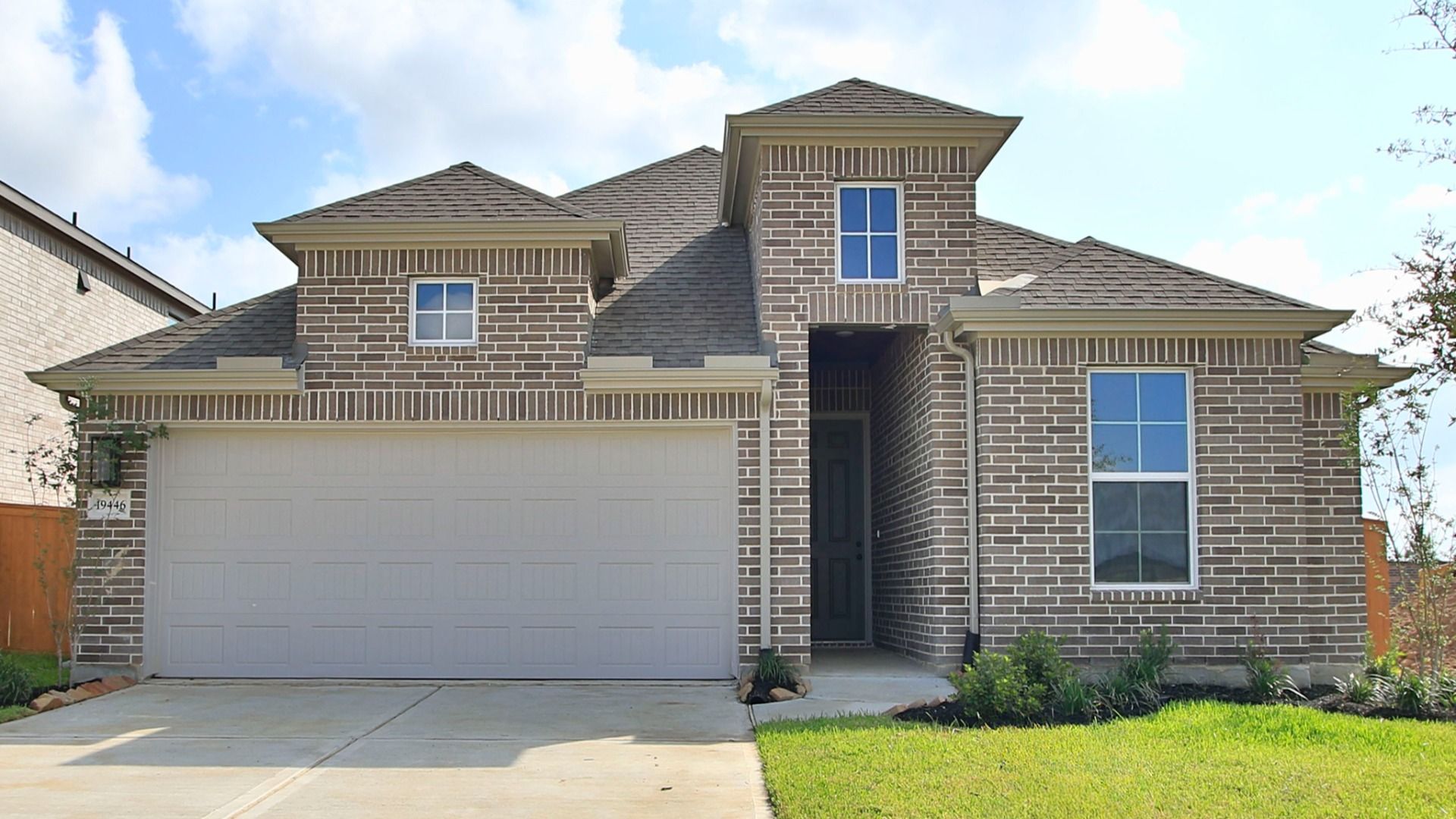Modern White Brick Home with Garage in Cypress Green:Elegant white brick facade with premium gray shingles in Cypress Green.