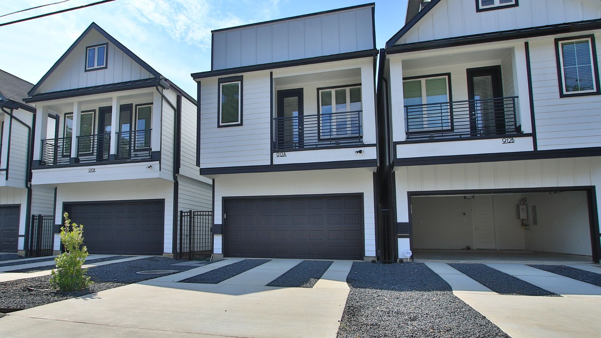 Two-story Home with Balcony and Garage in Shady Acres:Elegant Shady Acres home features a gray facade, expansive balcony, and sleek modern architecture.