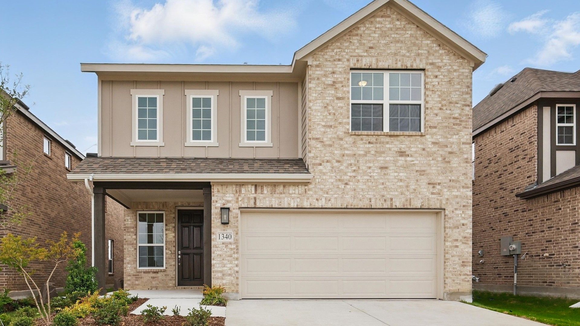 Elevation G:Elegant brick facade with modern design in Bel Air Village, offering spacious living.