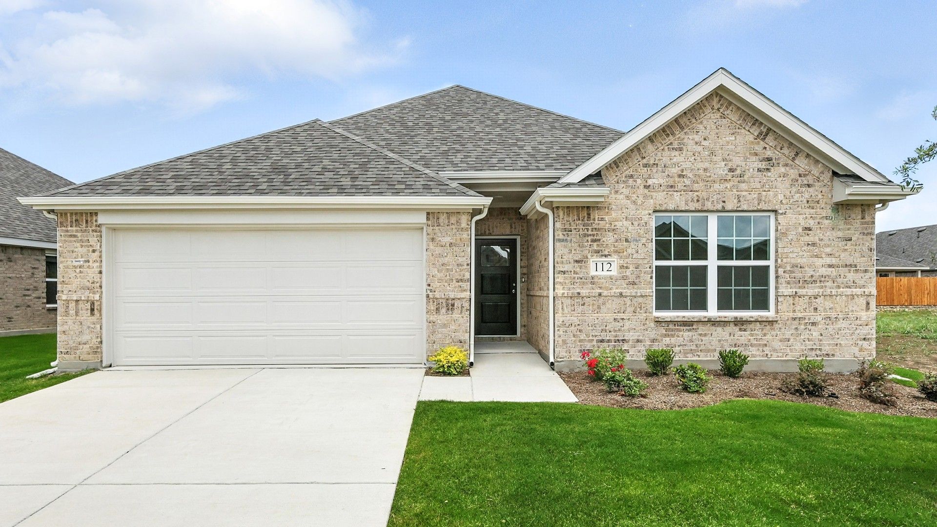 Modern Brick Home at Blanton, Patriot Estates, Texas:Elegant brick facade with pristine lawn and gabled roof at Blanton, Patriot Estates in Texas.
