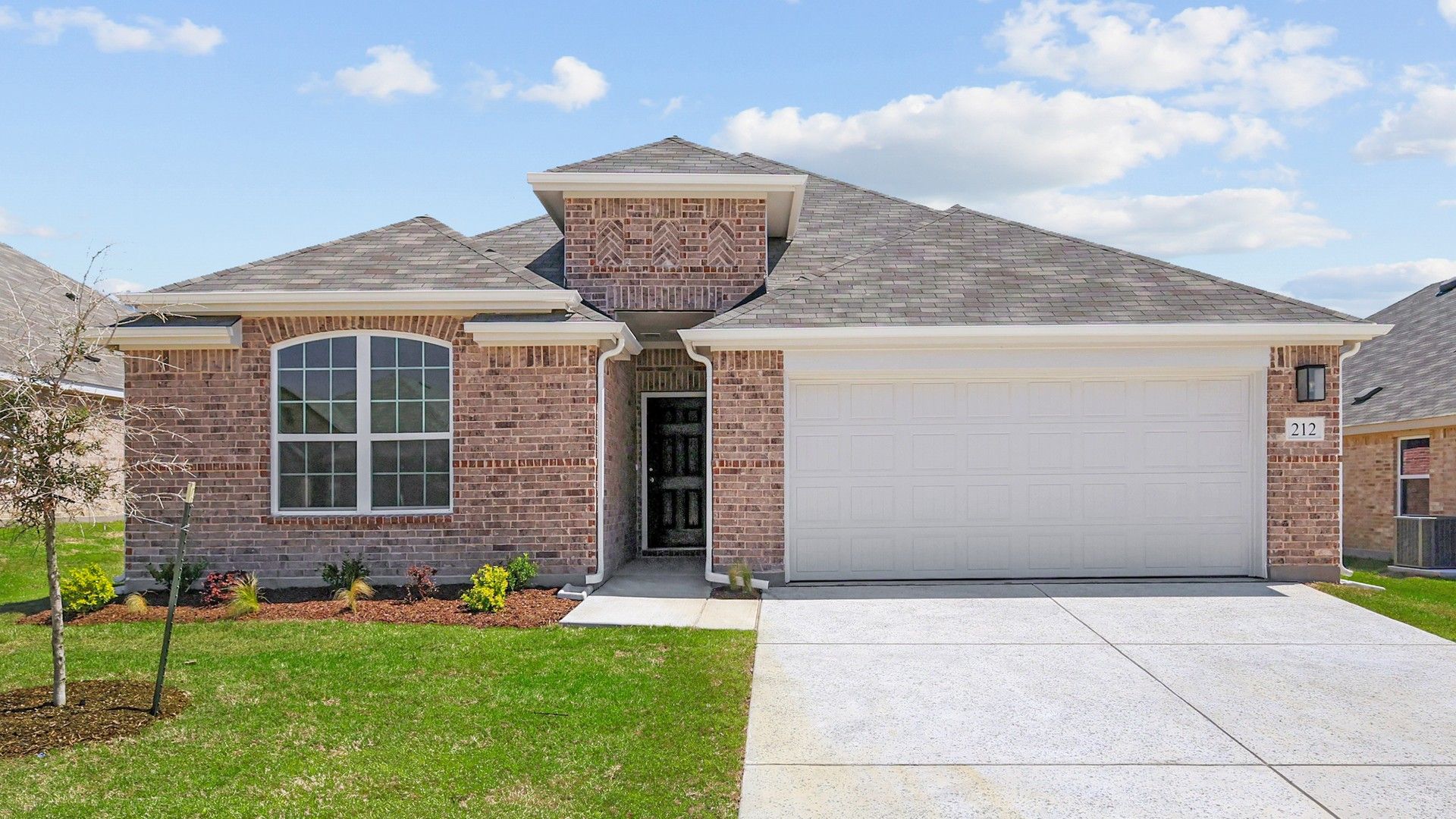 Modern Brick Home at Still Water Lake Estates with Arched Window and Garage:Elegant brick facade and arched windows blend timeless beauty and modern luxury at Still Water Lake Estates.