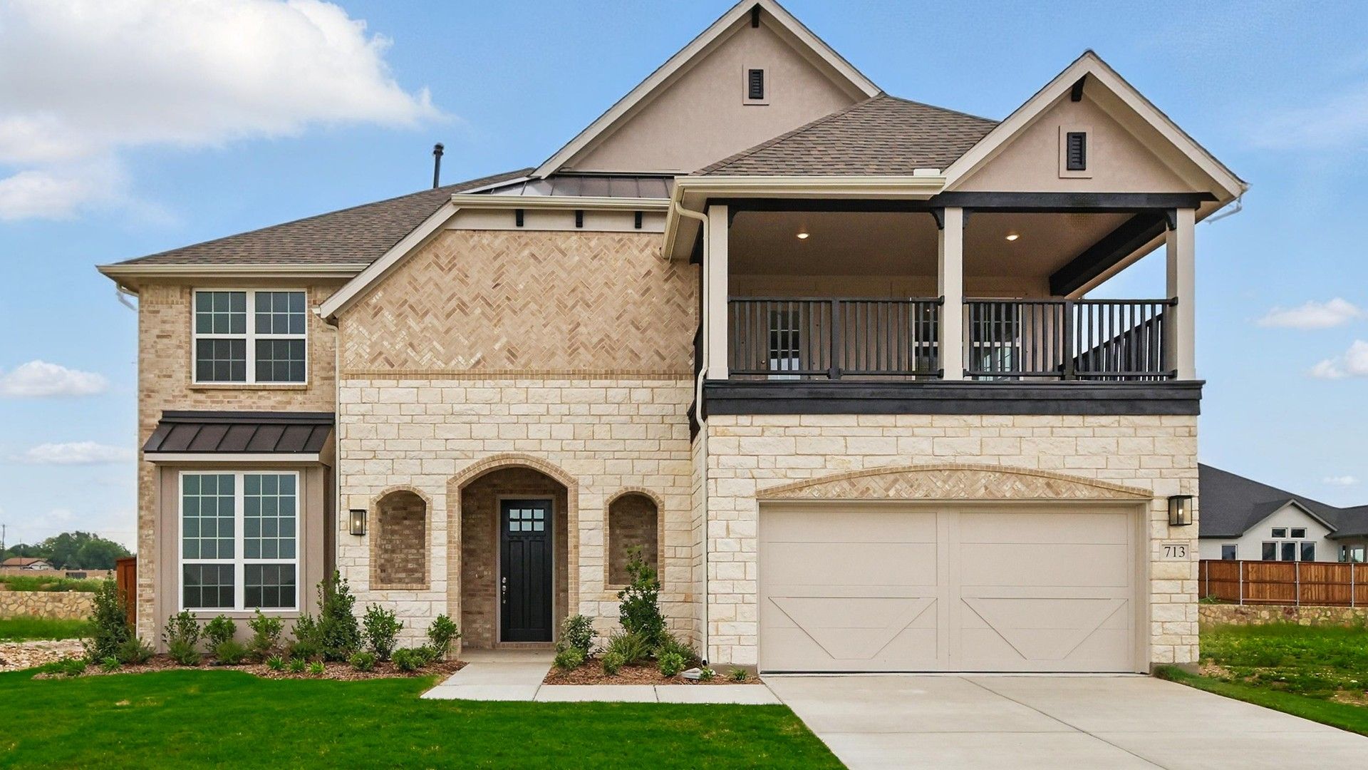 Elegant Two-story Home with Balcony in Rio Vista at Kelly Ranch:Experience opulence with stone and brick design, grand balcony, arched entryway in Rio Vista at Kelly Ranch.