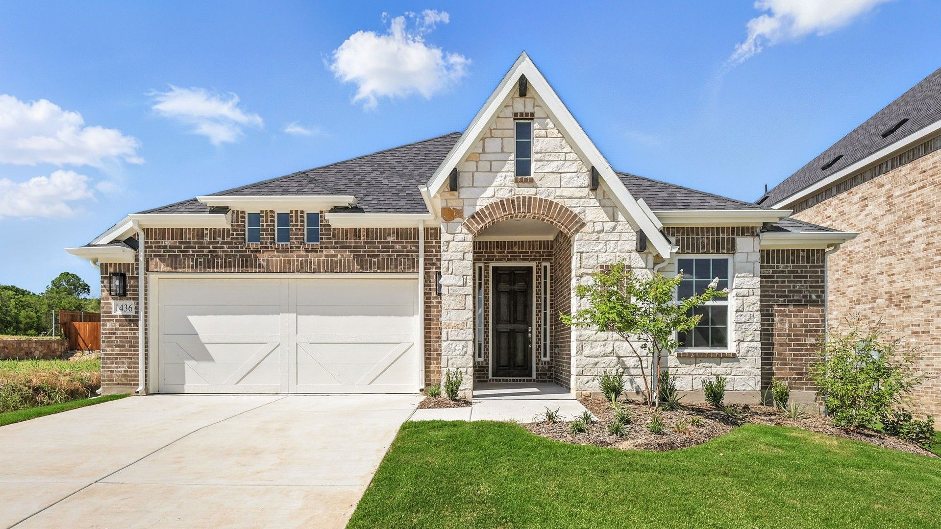 Elegant Stone and Brick Home in Green Oaks Preserve:Distinguished stone facade and immaculate landscaping enhance this Green Oaks Preserve residence's sophistication.