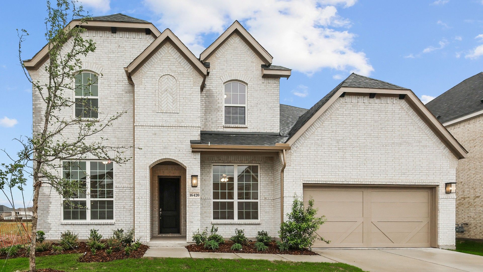 Elegant Brick Home in Dartmouth at Green Meadows Community:Refined brick exterior, dramatic gable roof, and luxurious finishes in Dartmouth at Green Meadows.