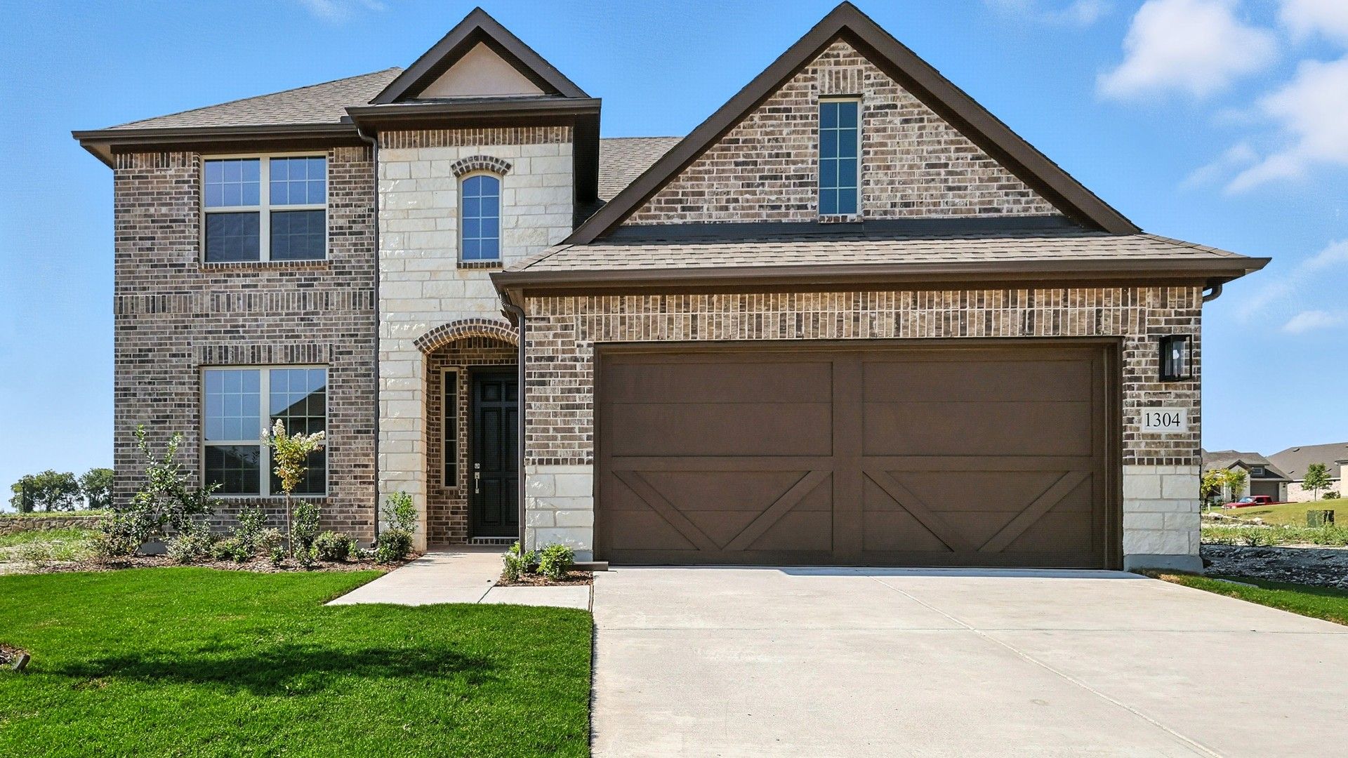 Hickory Floor Plan Exterior at 1304 Staffords Point Lane, Anna Ranch:Stunning brick and stone facade with elegant architectural details at Anna Ranch's Hickory plan.