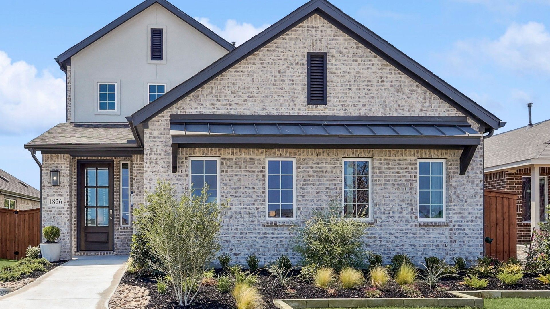 Modern Brick House in Walden Pond with Gabled Roof and Large Windows:Stunning brick facade, expansive windows in Walden Pond. Elegant gabled roof complements manicured landscape.
