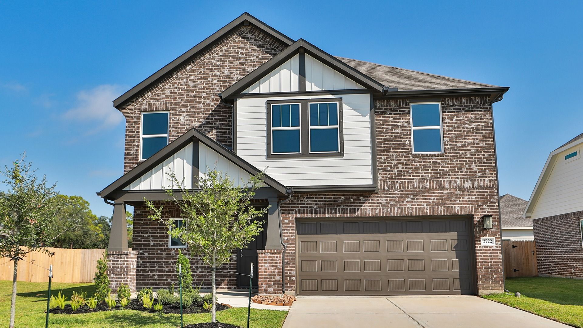 Contemporary Brick Home in Ellis Cove with Gable Roof and Spacious Garage:Experience luxury at Ellis Cove with a two-story brick facade, elegant gable roof, and meticulously landscaped yard.