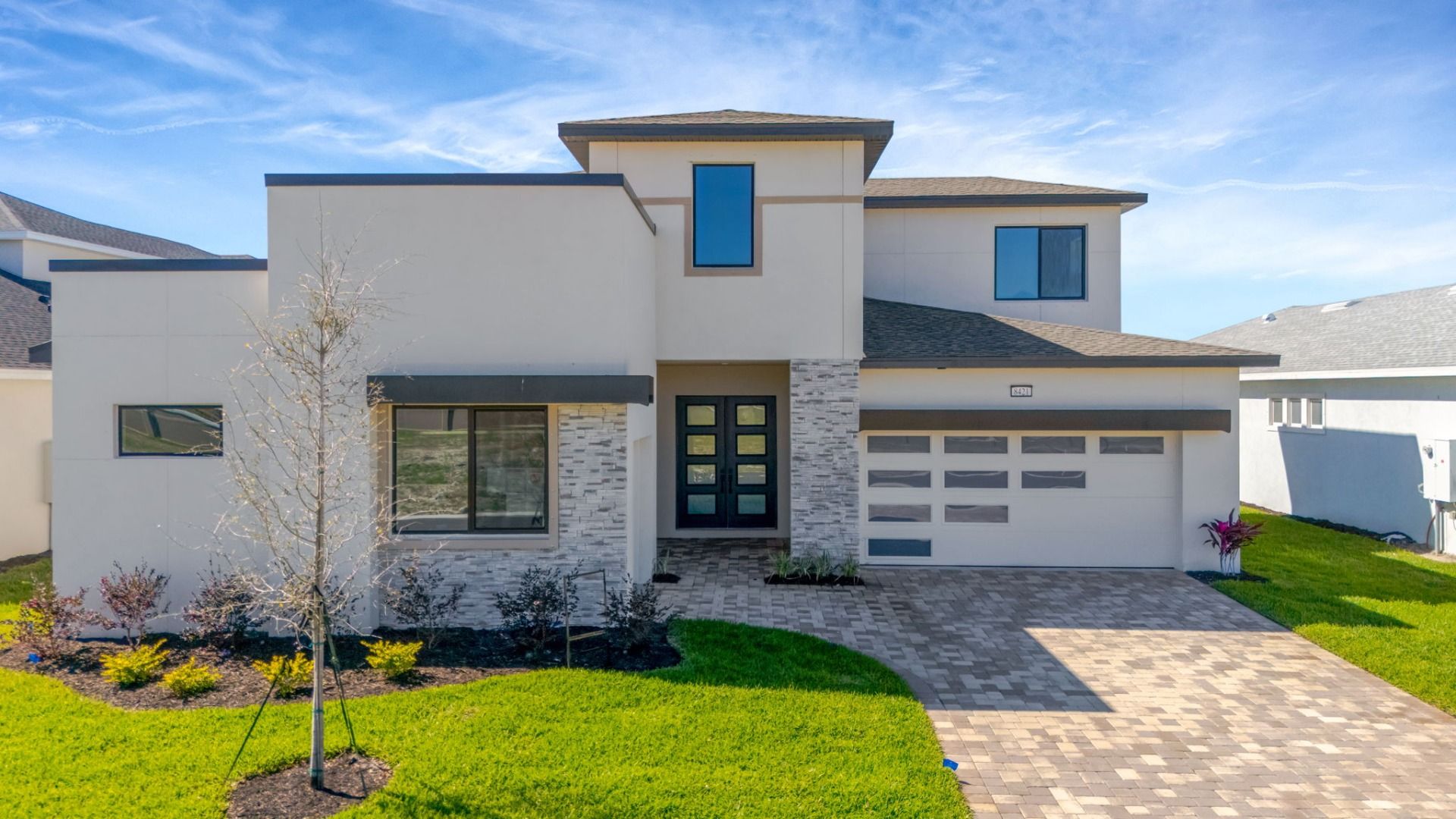 The Front Elevation:The Front Elevation of a DRB Homes Grand Hawk which is offered as a home plan at Serengeti in Spring Hill, FL.