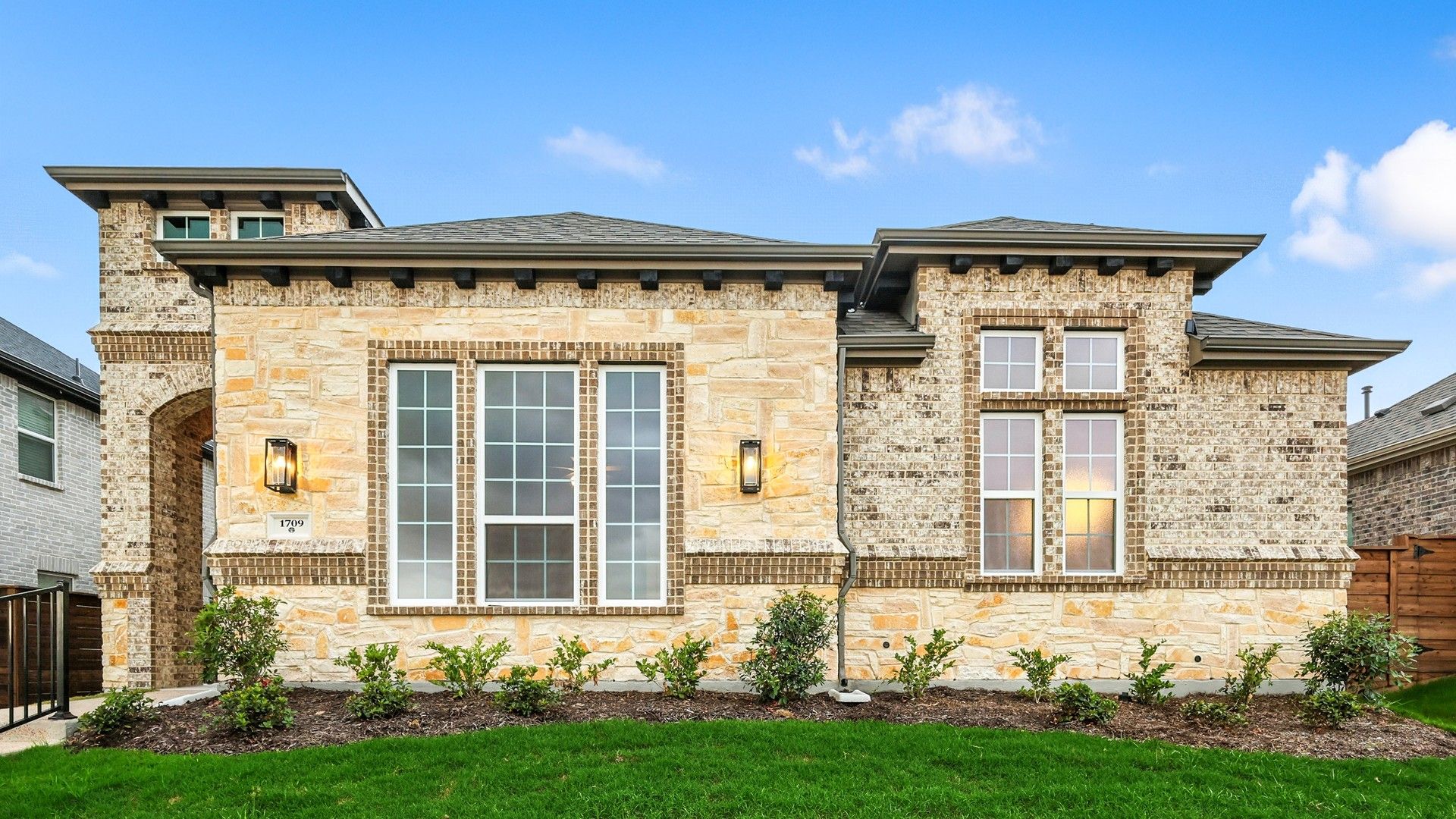 Nashville II Elegant Brick and Stone Home at Solterra Texas:Luxurious brick and stone facade with manicured gardens in Solterra, Texas, emanating sophistication.
