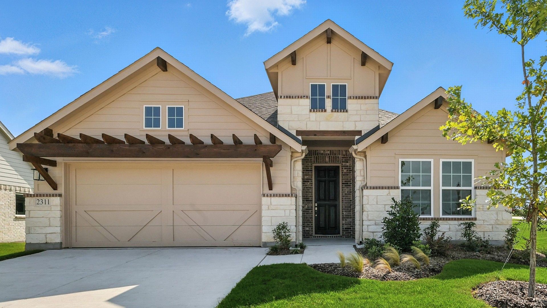 Contemporary Home with Stone Accents in Pebblebrook:Elegant gabled roof and striking stone accents in Pebblebrook offer sophisticated curb appeal.