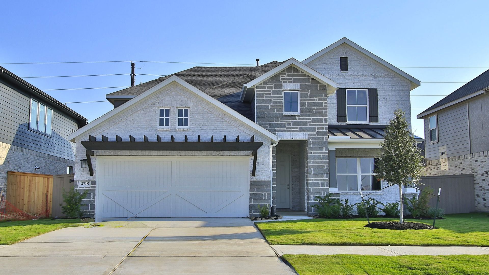 Two-Story Stone House in Creekhaven with Gable Roof and Landscaping:Luxurious stone facade, gable roof, elegant wooden shutters in Creekhaven community.