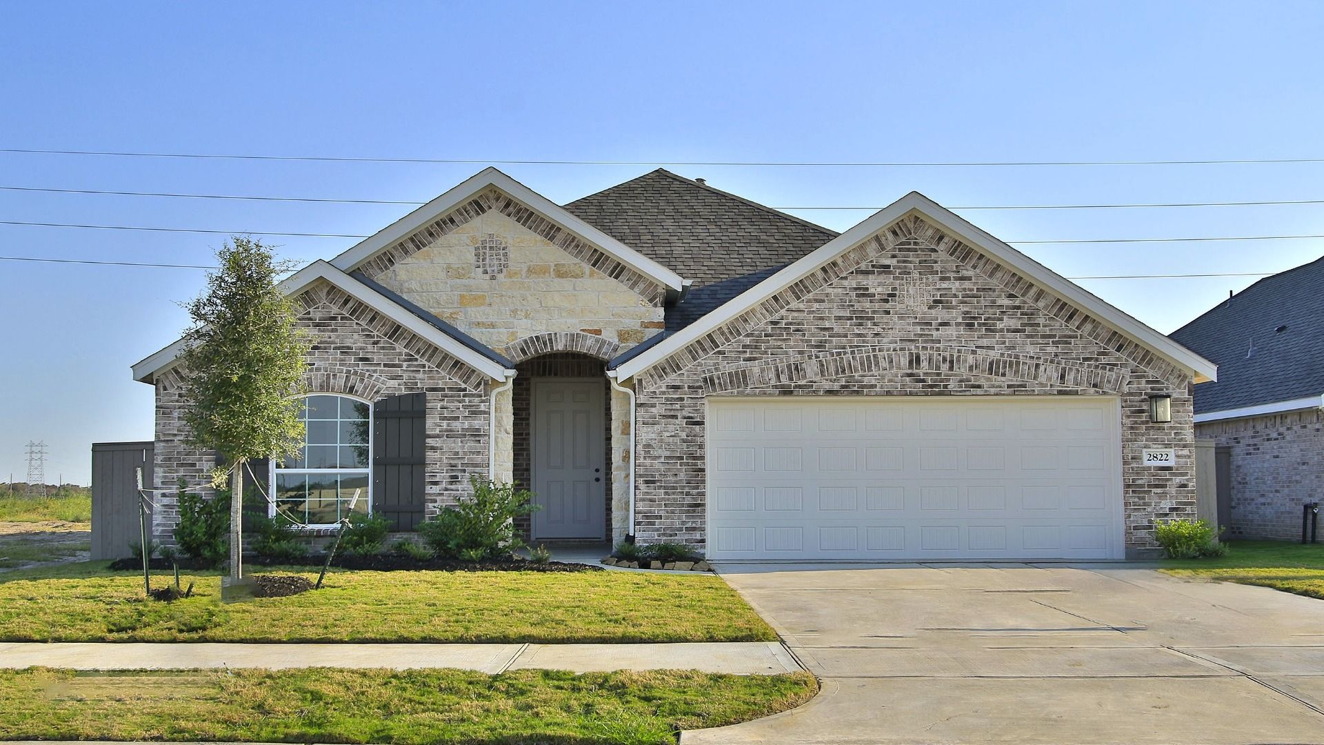 Elegant Brick House with Arched Doorway in Creekhaven:Experience luxury with arched entrances and classic brickwork in the exclusive Creekhaven community.