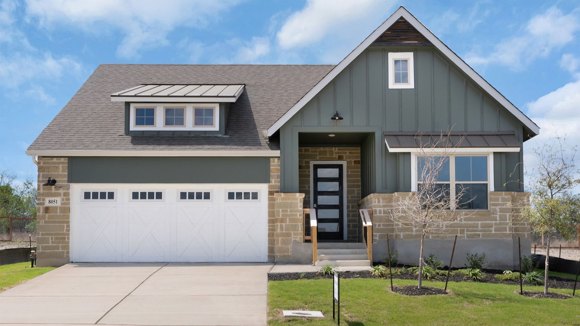 DSC04444.jpg:8051 Coral Draw. Beautiful exterior with rock-accented entry and inviting front porch.
