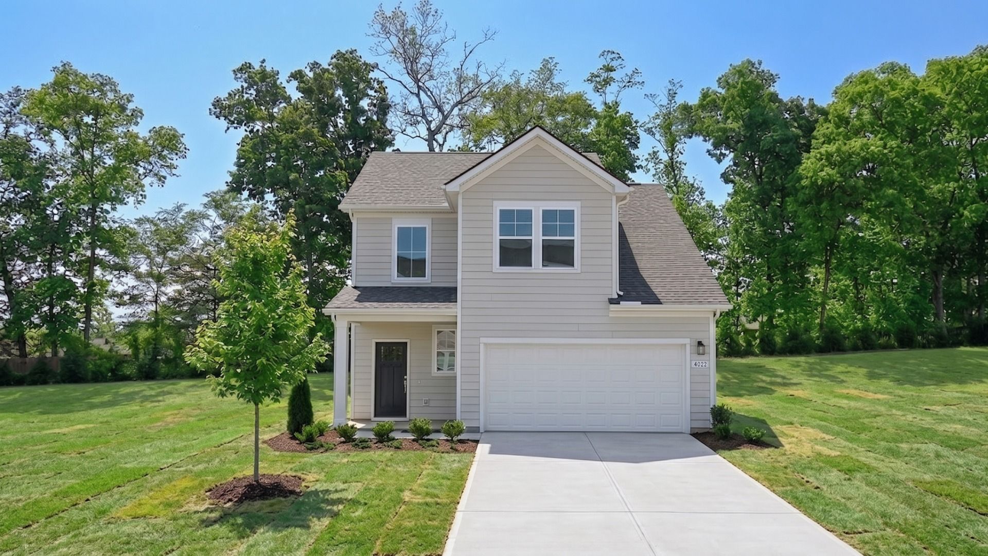 Freesia Plan Exterior:Exterior of Freesia plan home in Smyrna, TN with light colored Hardie Siding