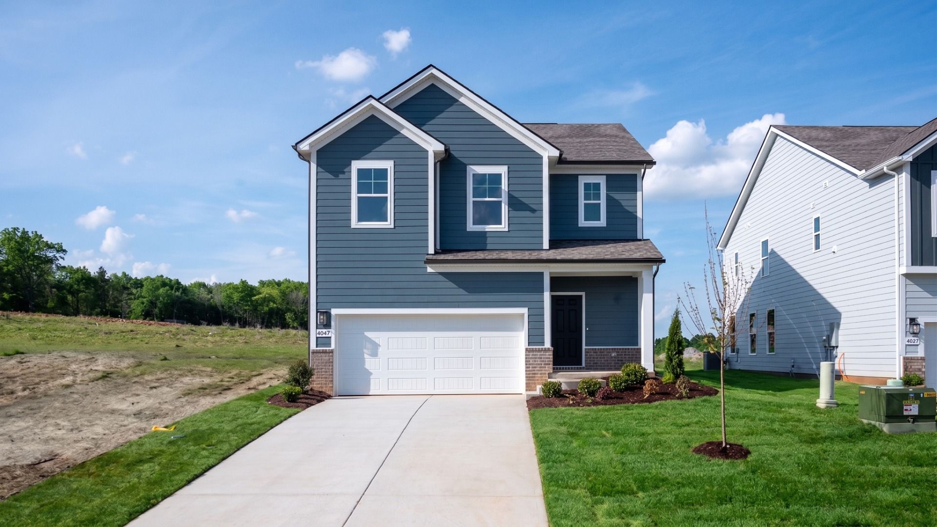 Beramont Plan Exterior:Exterior of 2-story Beramont plan in Smyrna, TN with blue Hardie siding and brick skirt