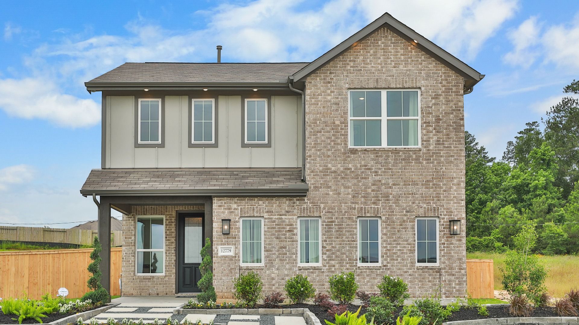 Modern Two-Story Brick House in Mostyn Springs:Elegant brick facade with sleek lines and expansive windows. Mostyn Springs offers landscaped serenity.