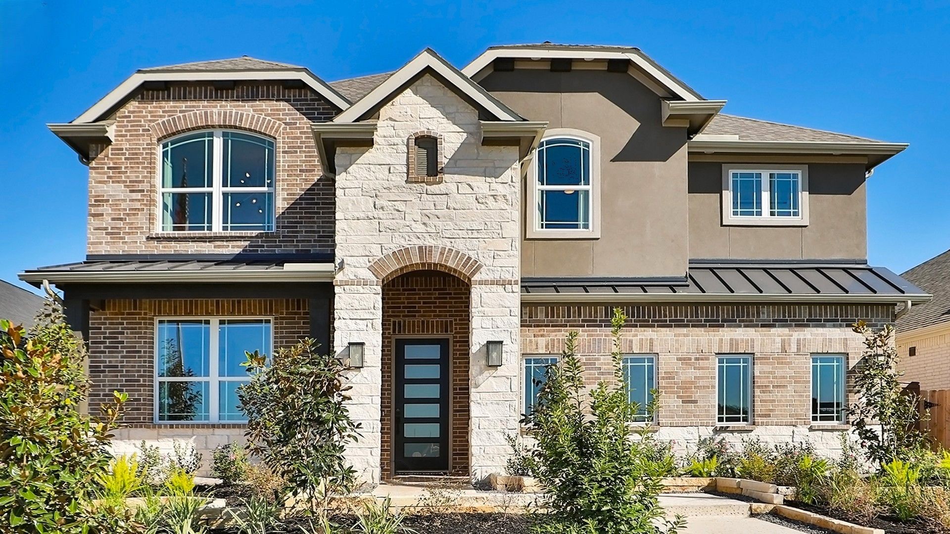 Modern Two-Story Brick and Stone House, Brookewater Community:Exquisite brickwork and arched windows define this modern Brookewater residence.