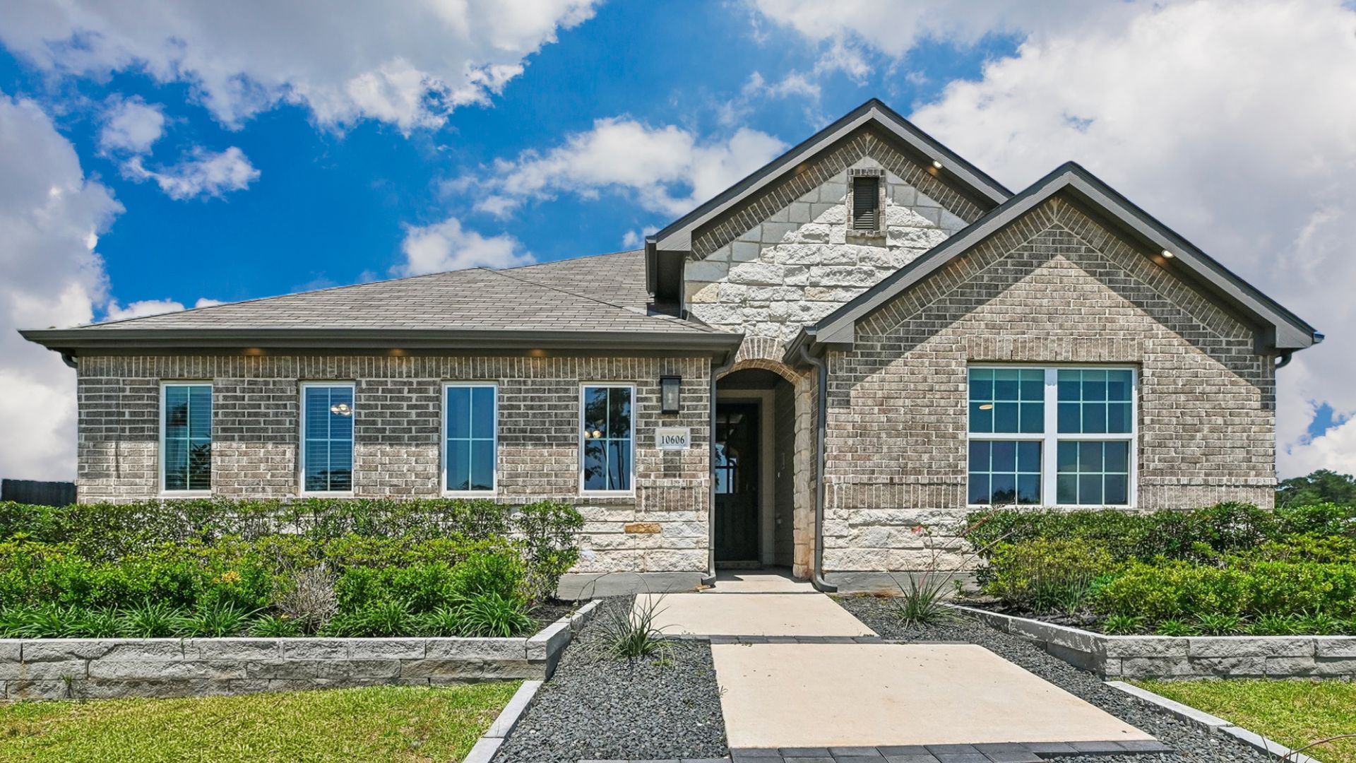 Elegant Brick House in Cielo Community with Gable Roof and Large Windows:Distinguished single-story home with refined brickwork and gable roofing in the exclusive Cielo enclave.
