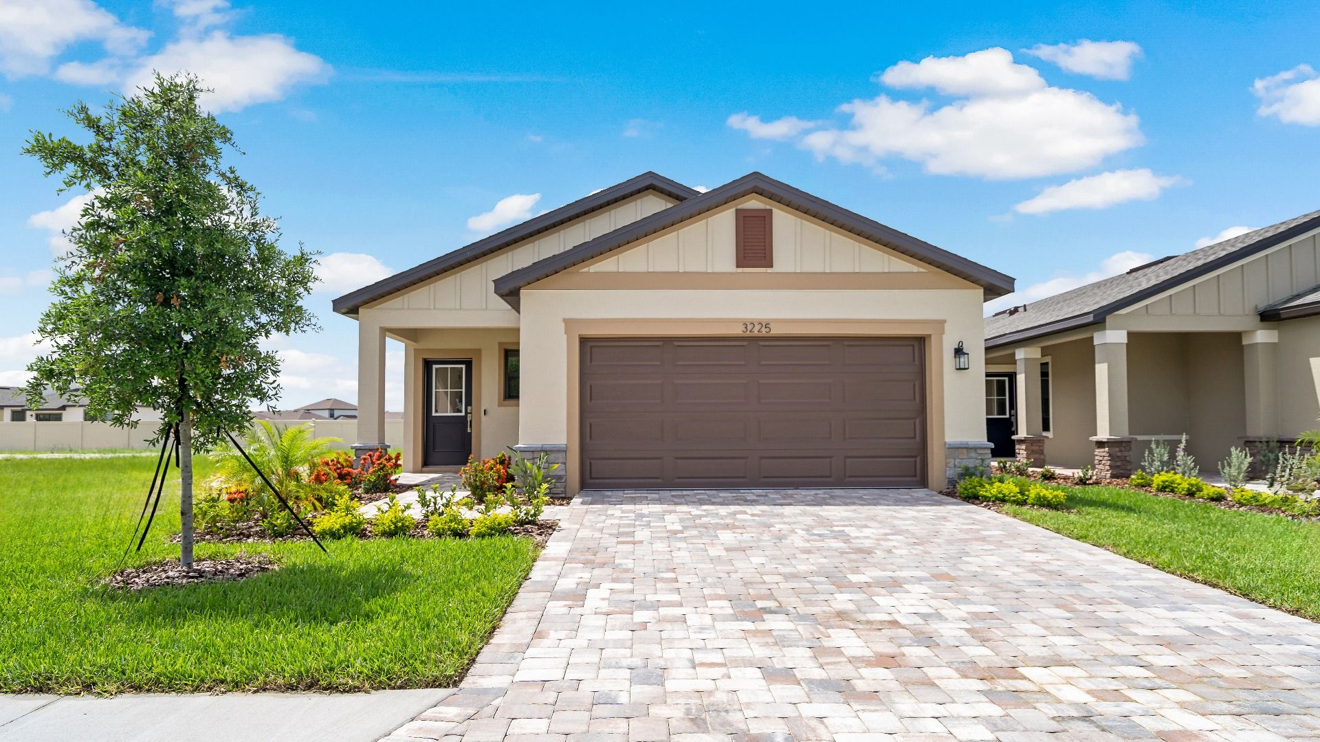 Exterior:New single-story home in Lakeland, FL The Atlantic by DRB Homes at Grasslands West with 2-car garage and open-concept design.