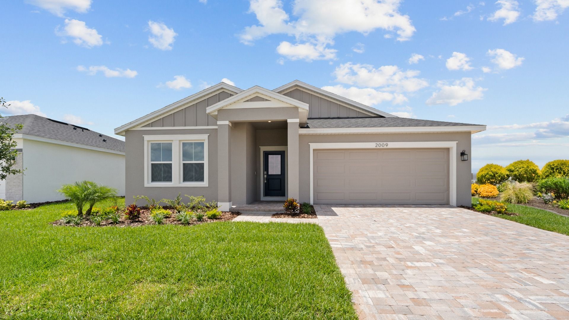 Castaway:Buttonwood model in coastal elevation with two-car garage and modern curb appeal