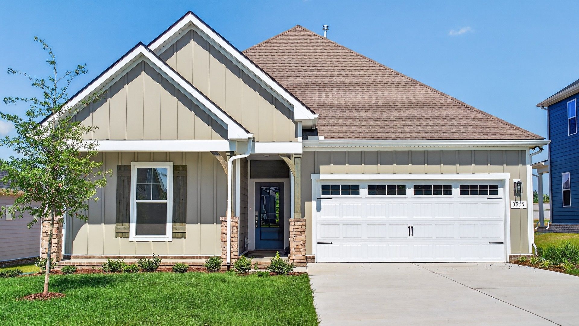 Modern Farmhouse with Gable Roof in McClure Farms:Stylish gable roof and stone accents enhance this McClure Farms home's refined suburban elegance.