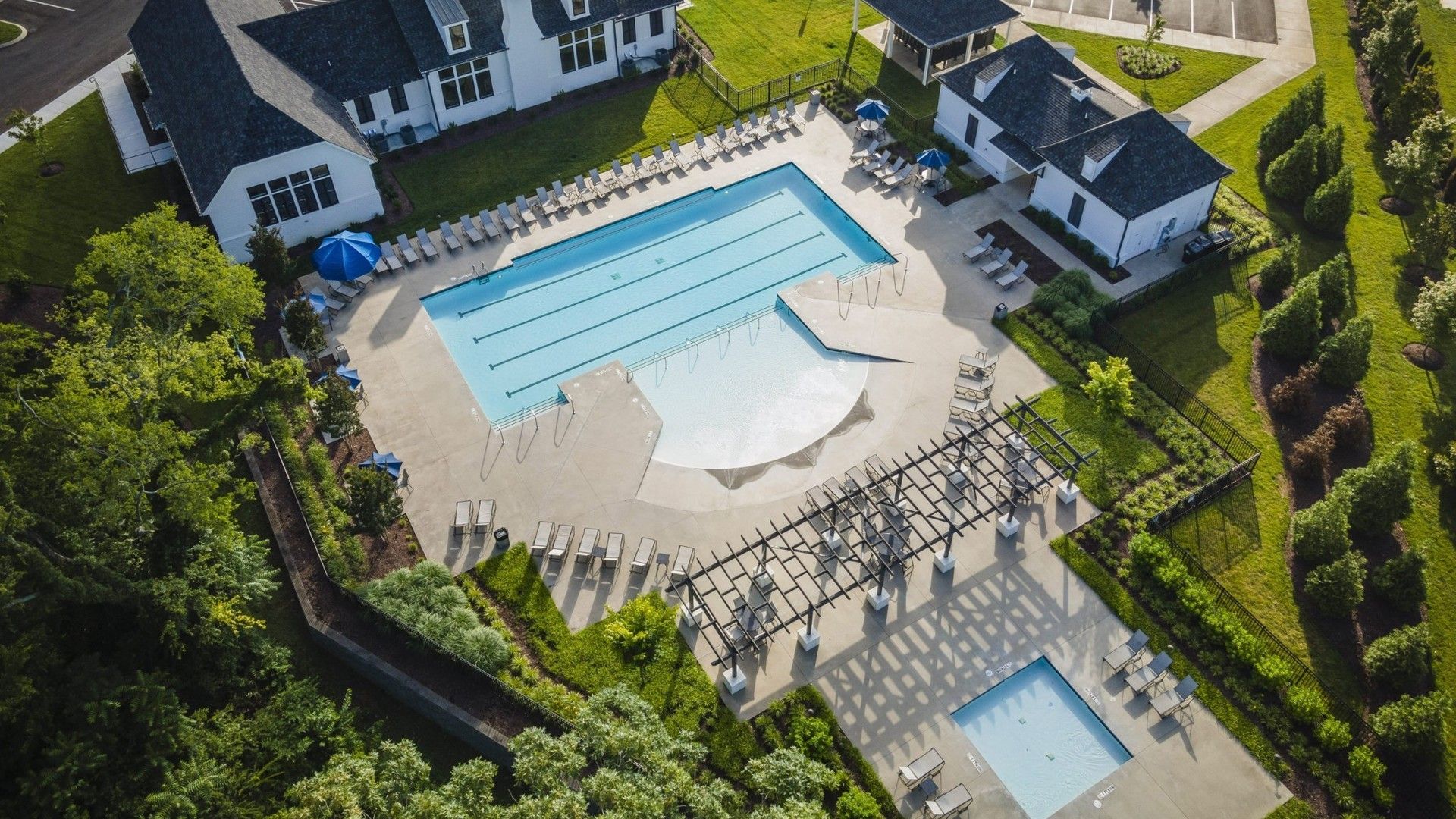 Shelton Square Community Pool with Clubhouse in Tennessee:Experience refined elegance at Shelton Square's luxury clubhouse and pristine pool with lush landscaping, Tennessee.