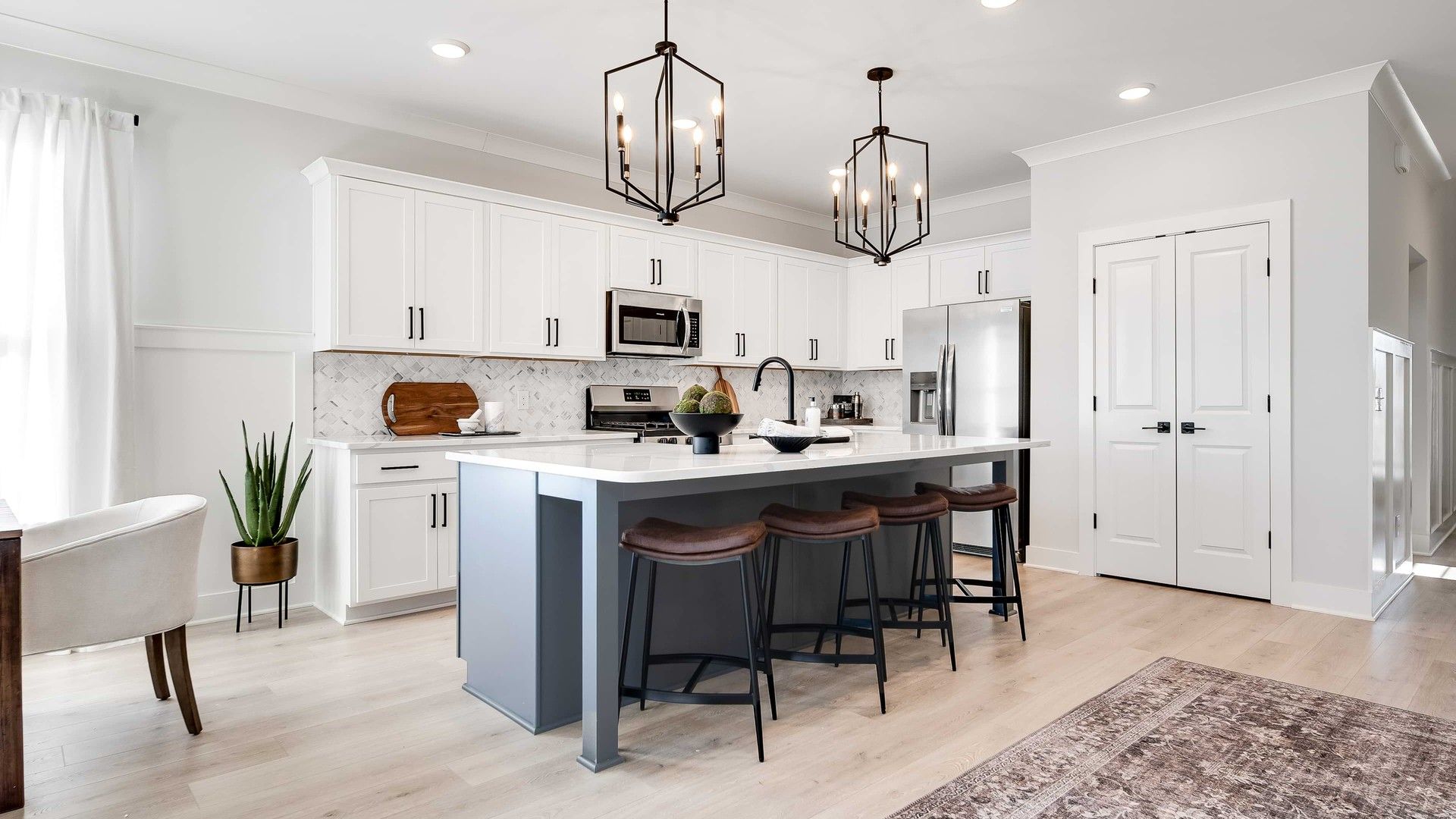 Modern Kitchen with Island and Pendant Lights in Richvale Estates:Elegant kitchen showcases marble backsplash, luxe island, and chic pendant lighting. Richvale Estates premier location.