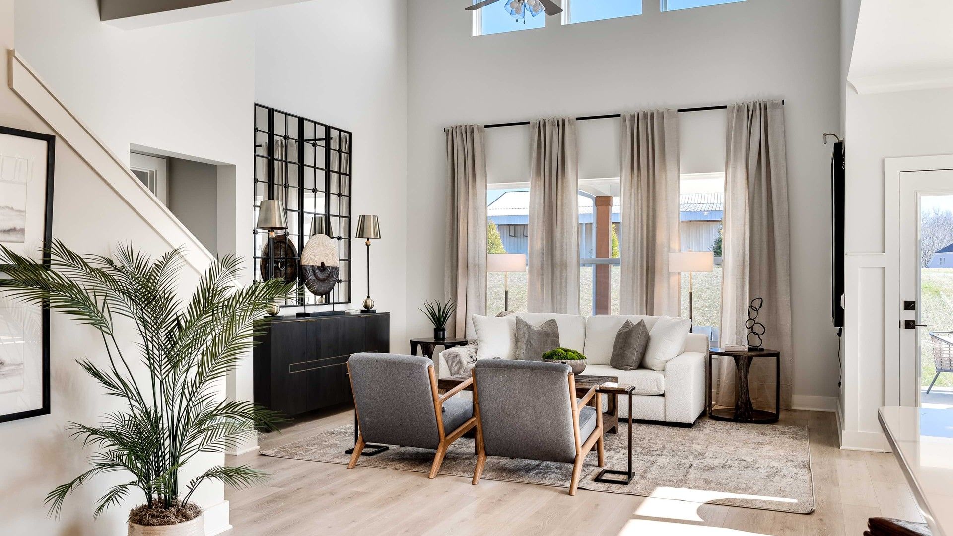 Elegant Living Room with High Ceiling and Modern Decor in Richvale Estates:Experience refined living with soaring ceilings, expansive windows, and chic decor. Located in Richvale Estates.