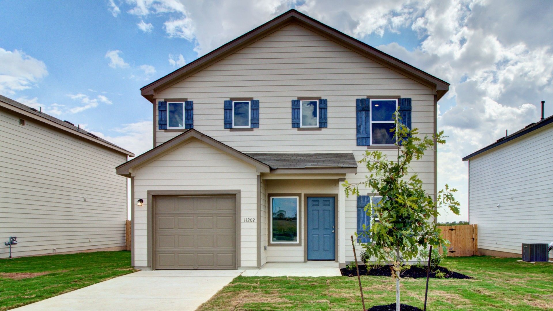 Prairie Green Element Topaz Home at 11202 Prairie Landing:Elegant Prairie Green home with charming brown shutters and manicured lawn at 11202 Prairie Landing.