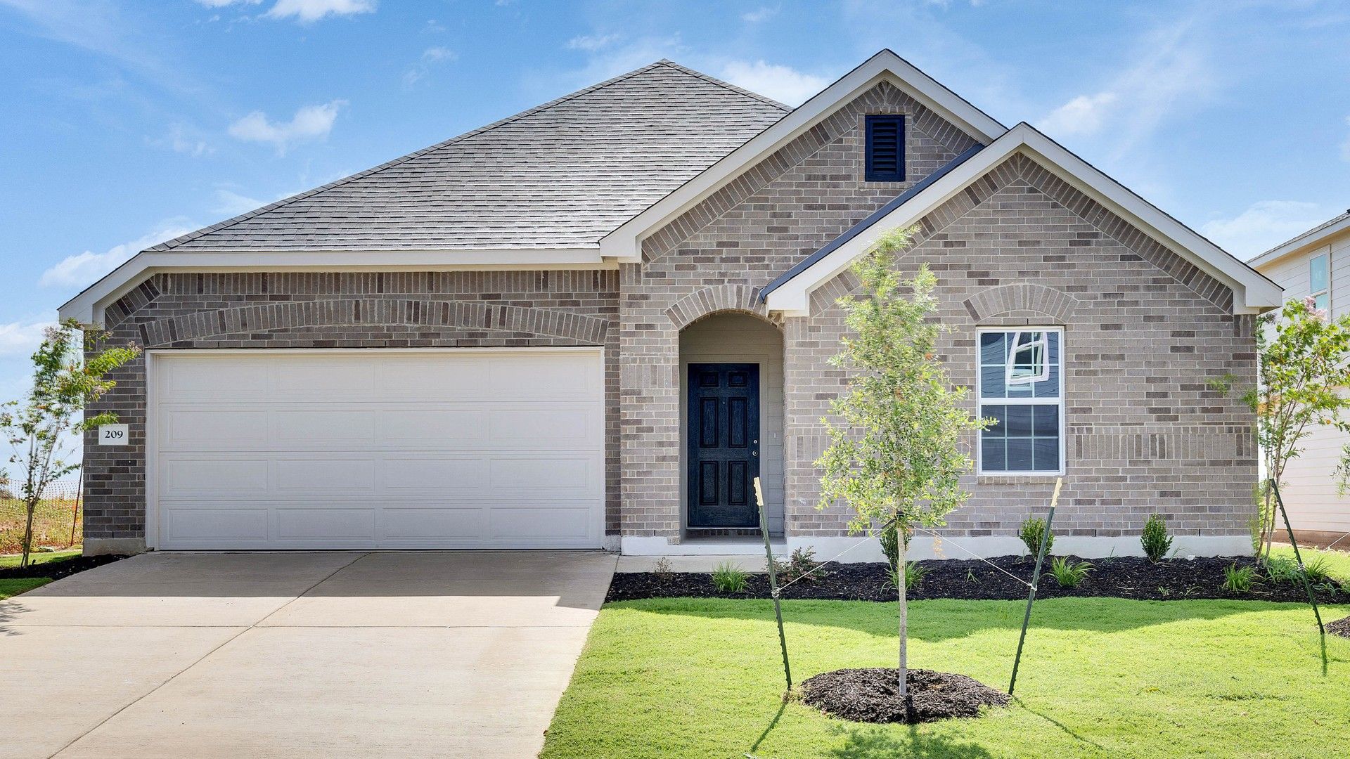 Elevation P:Experience classic elegance with a brick facade and meticulously landscaped garden in Avalon at Hunters Glen.