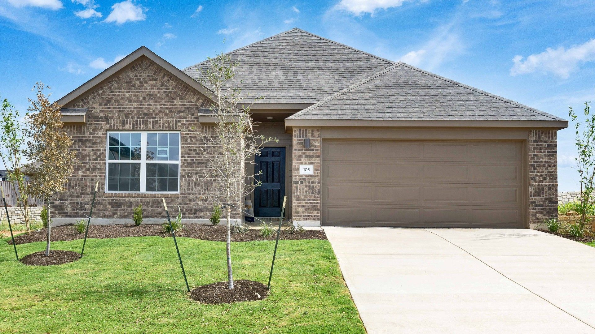 Elevation M:Sophisticated red brick facade and pristine landscape in Blanton at Hunters Glen offer classic suburban elegance.