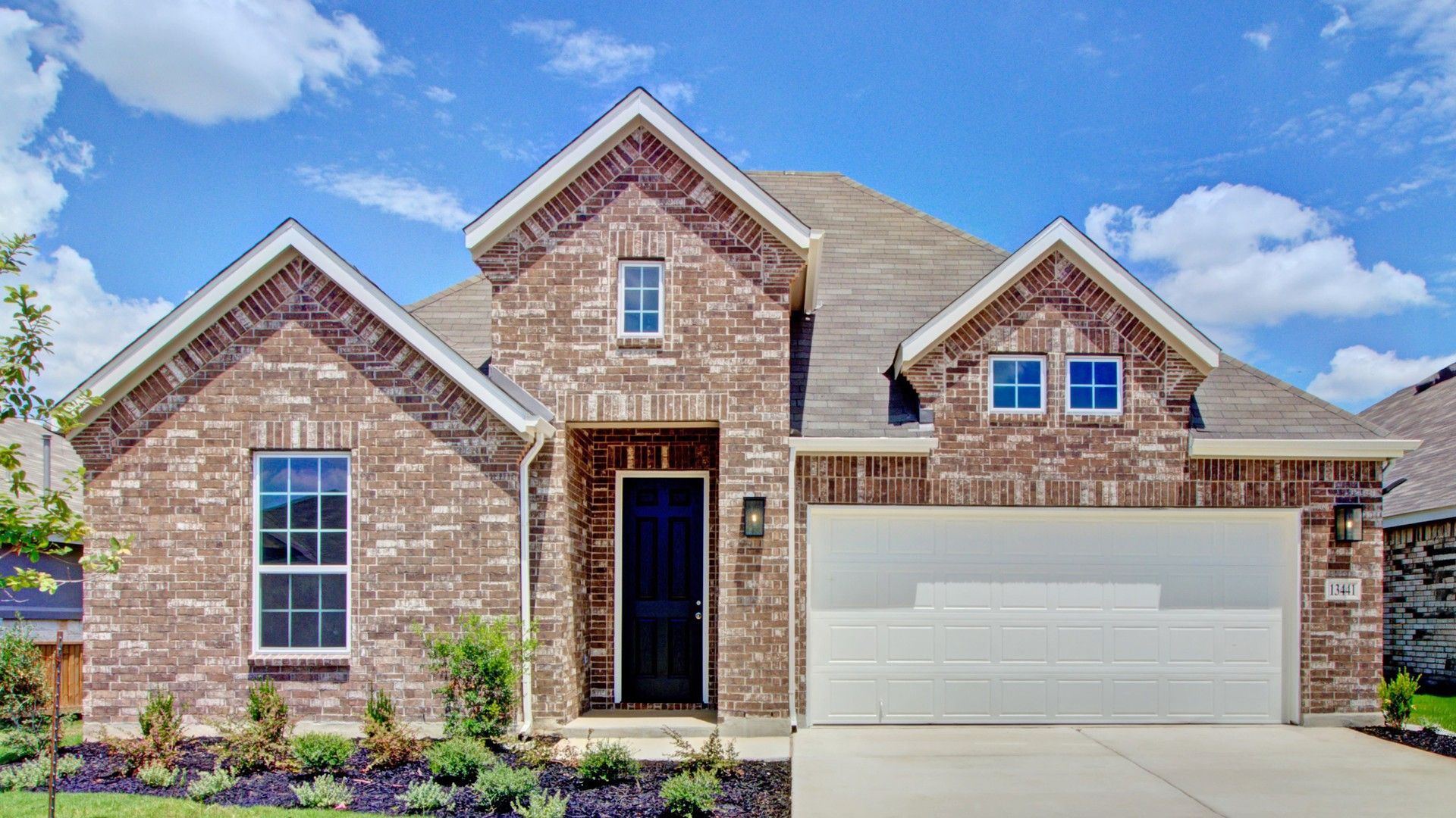 Brick Home at 13441 Cosette Crossing in Veranda Community:Elegant brick facade with gabled roof in Veranda's premier single-family home community.