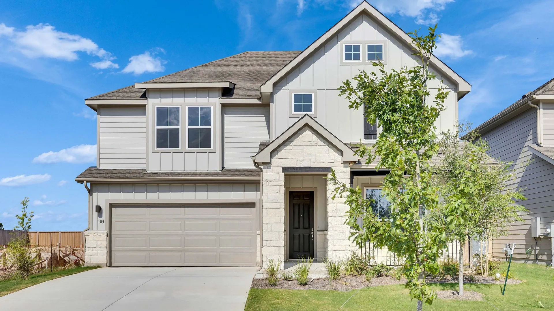 Spring Creek Magnolia Plan Home at 105 Greinert Drive with Stone Facade:Elegant stone facade and lush landscaping at 105 Greinert Drive in Spring Creek.