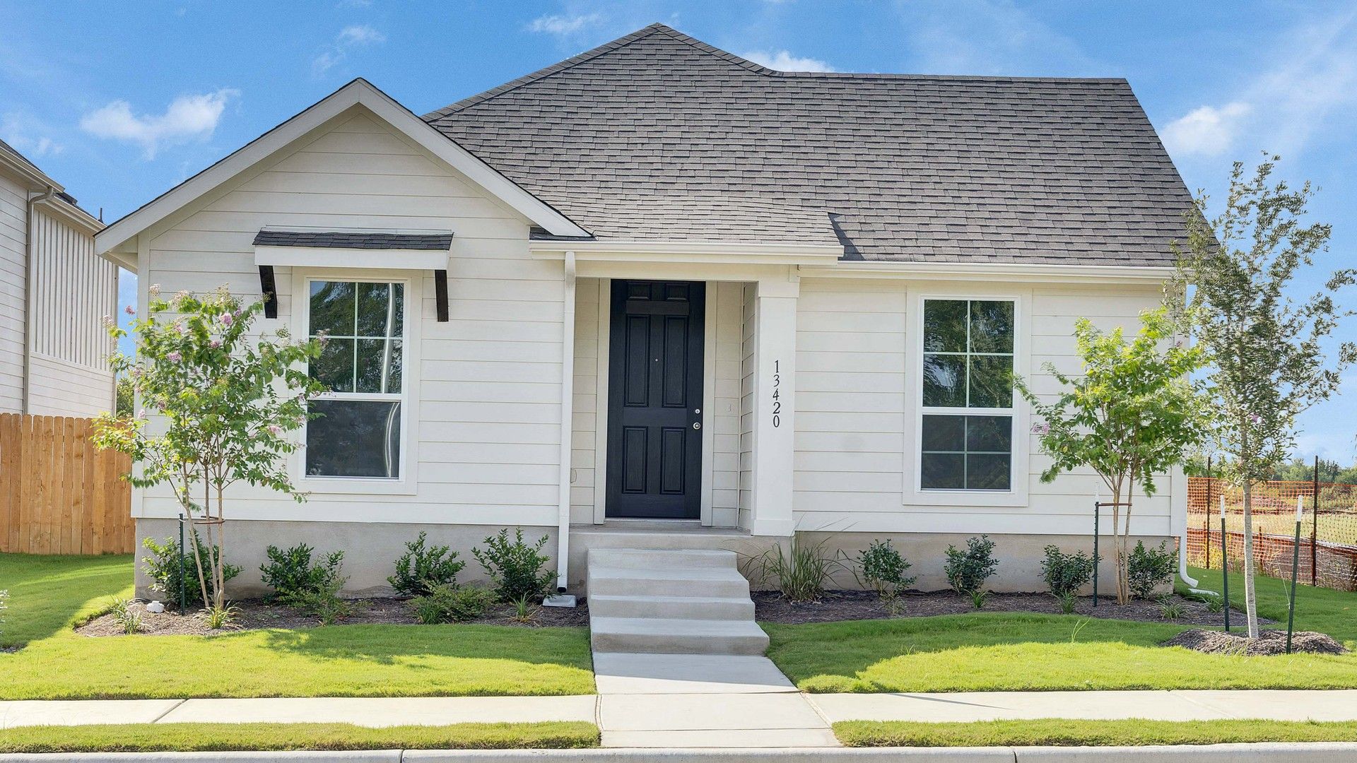 Elevation A:Elegant gabled roof and sleek beige siding define this Creeks Crossing residence's sophisticated charm.