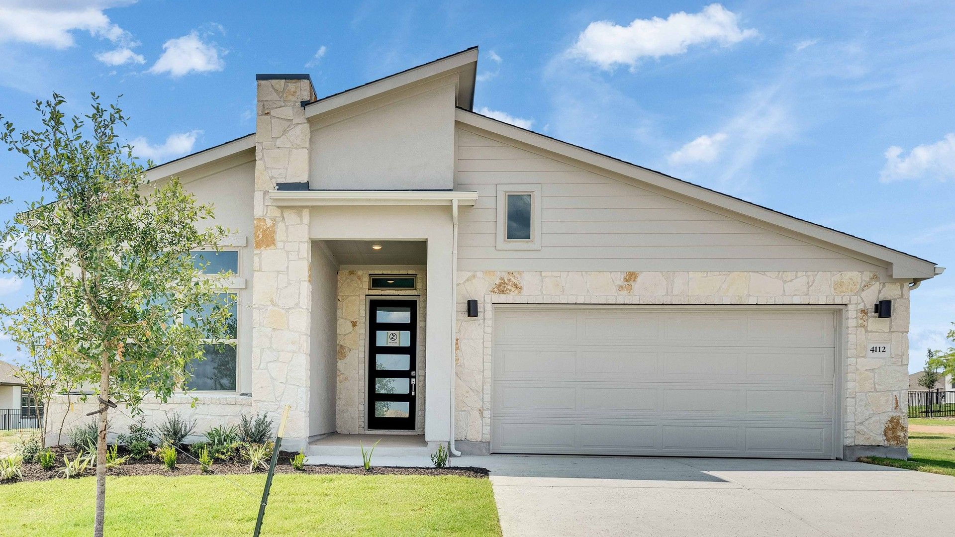 Contemporary Stone and Stucco Home in Lakeside Meadows:Elegant gable roof and stone facade complement the landscaped entrance in stunning Lakeside Meadows.