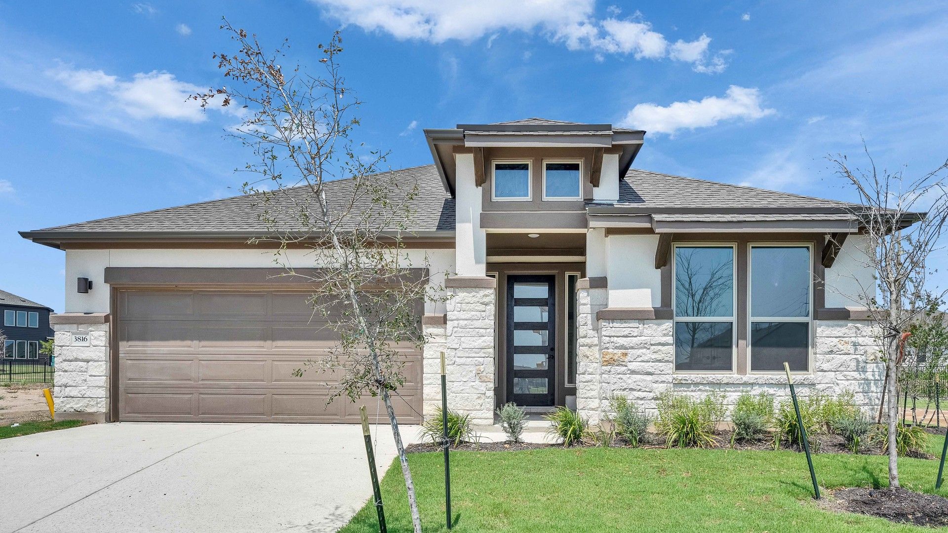 Modern Stone Facade Home at Preserve at Lakeside Meadows:Impeccable stonework and sleek design define this home's elegant facade in Preserve at Lakeside Meadows.