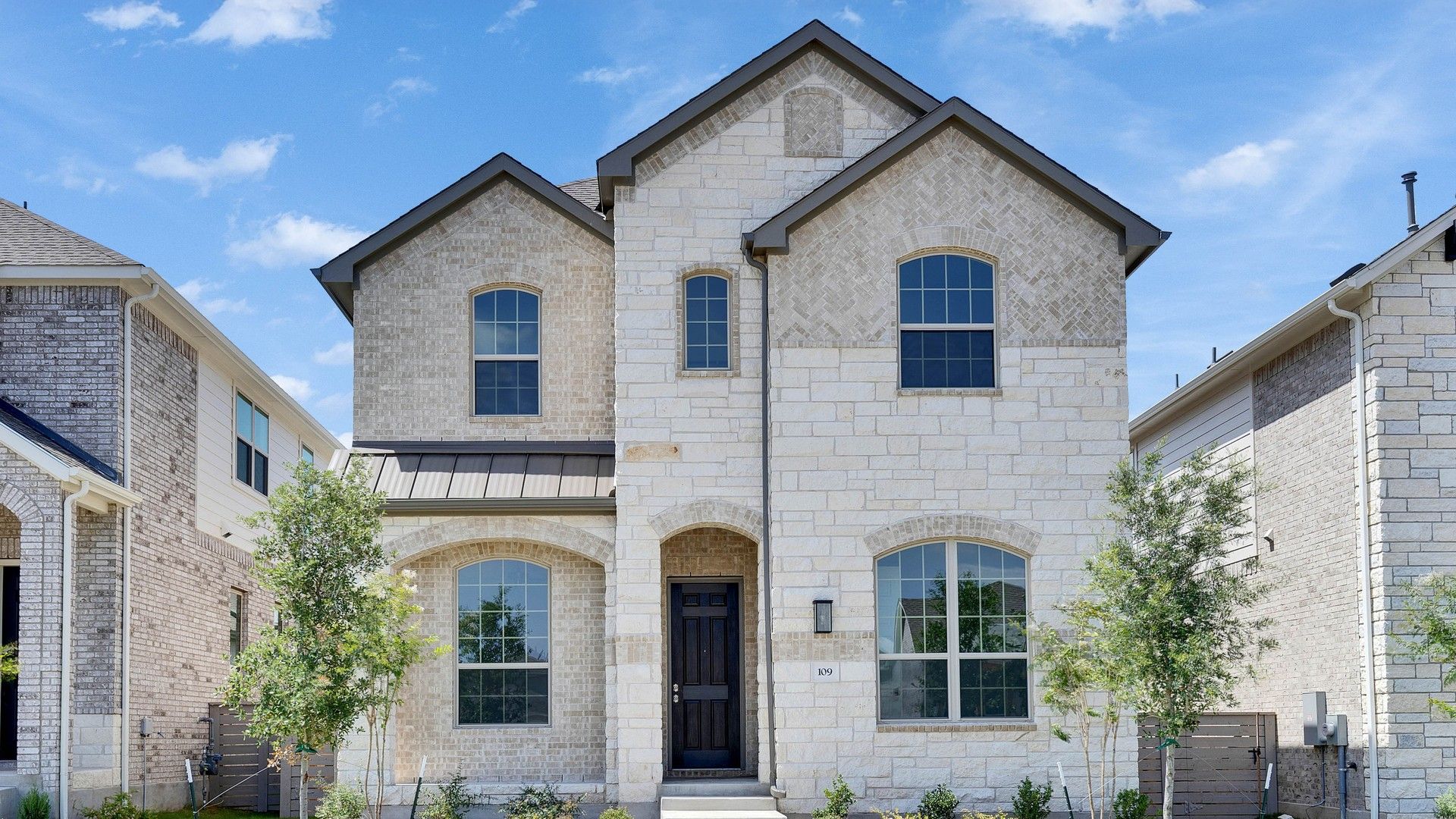 Stone Facade Two-Story House in Suburban Neighborhood:Exquisite stonework and elegant archways define this stunning residence, set in a serene suburban locale.