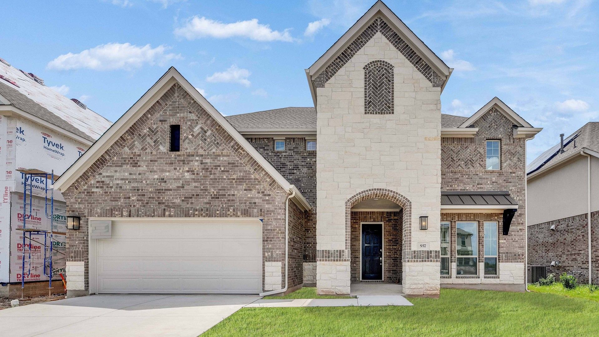 Luxurious Two-Story Brick Home at Stanford, Hawkes Landing:Bask in this Hawkes Landing home's grand arched entry and refined brickwork, exuding unparalleled elegance.