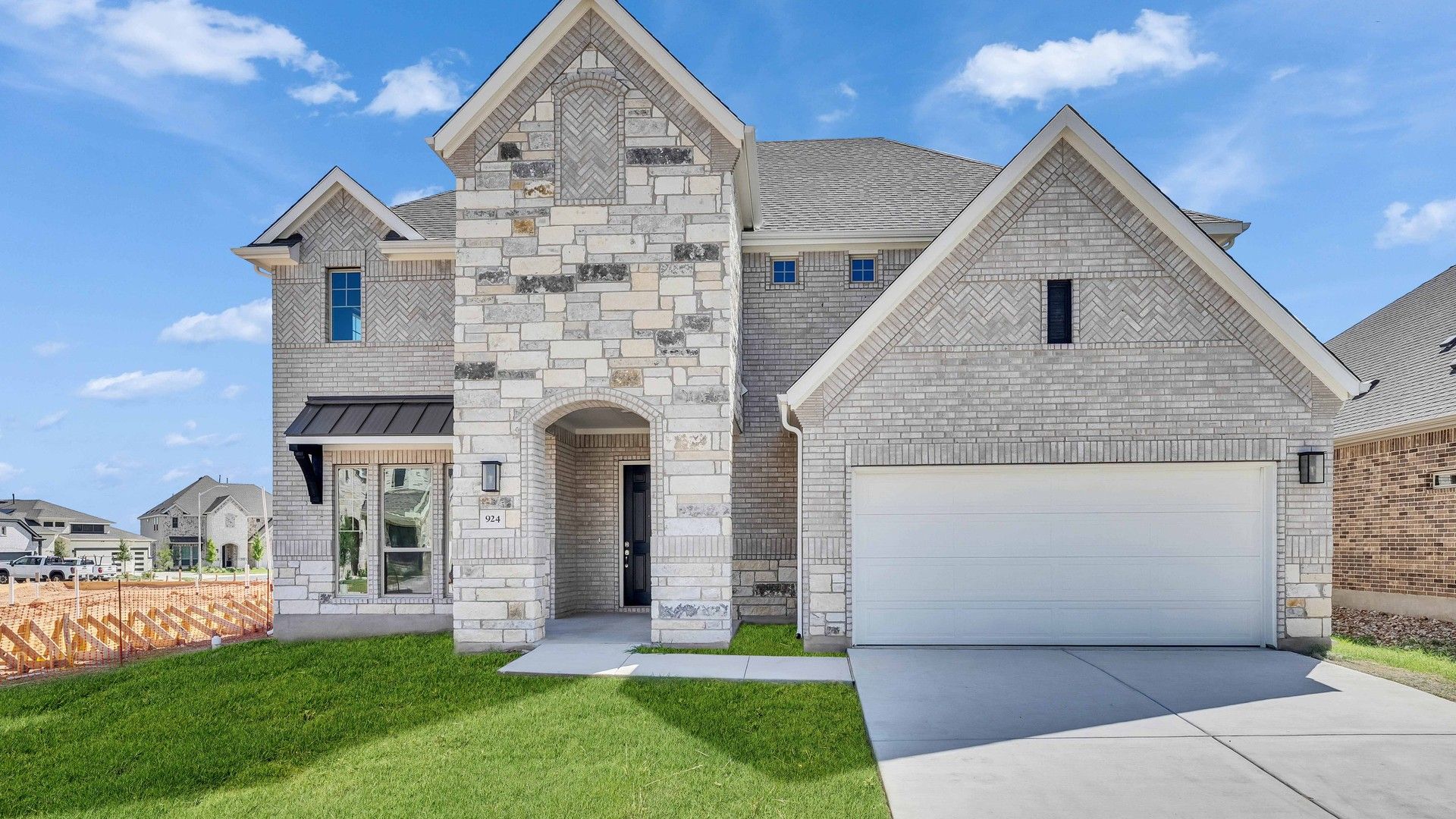 Majestic Stone and Brick House in Hawkes Landing:Exquisite stone facade, arched entry, and lush landscaping in Hawkes Landing create unparalleled elegance.