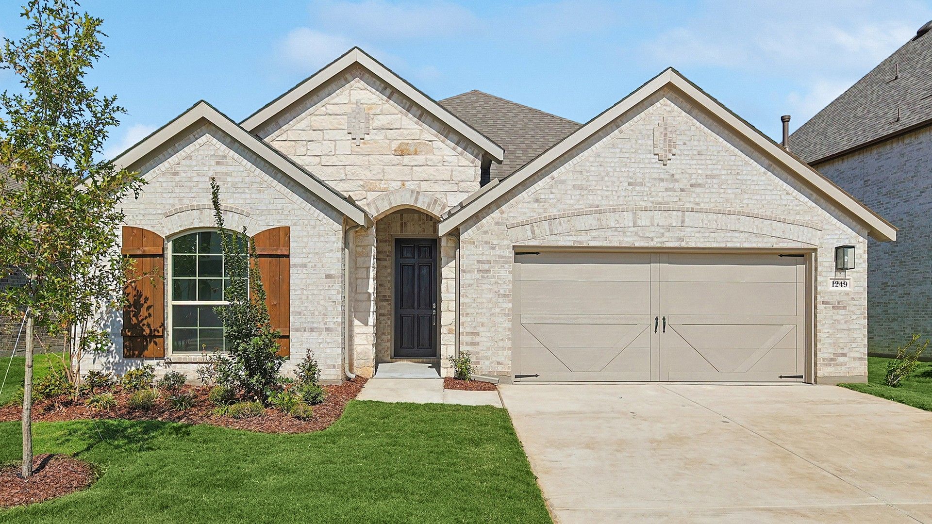 Elegant Stone Facade Home in Stream Waters Community:Exquisite stone facade, arched entryway, Stream Waters. Meticulous landscaping enhances curb appeal.
