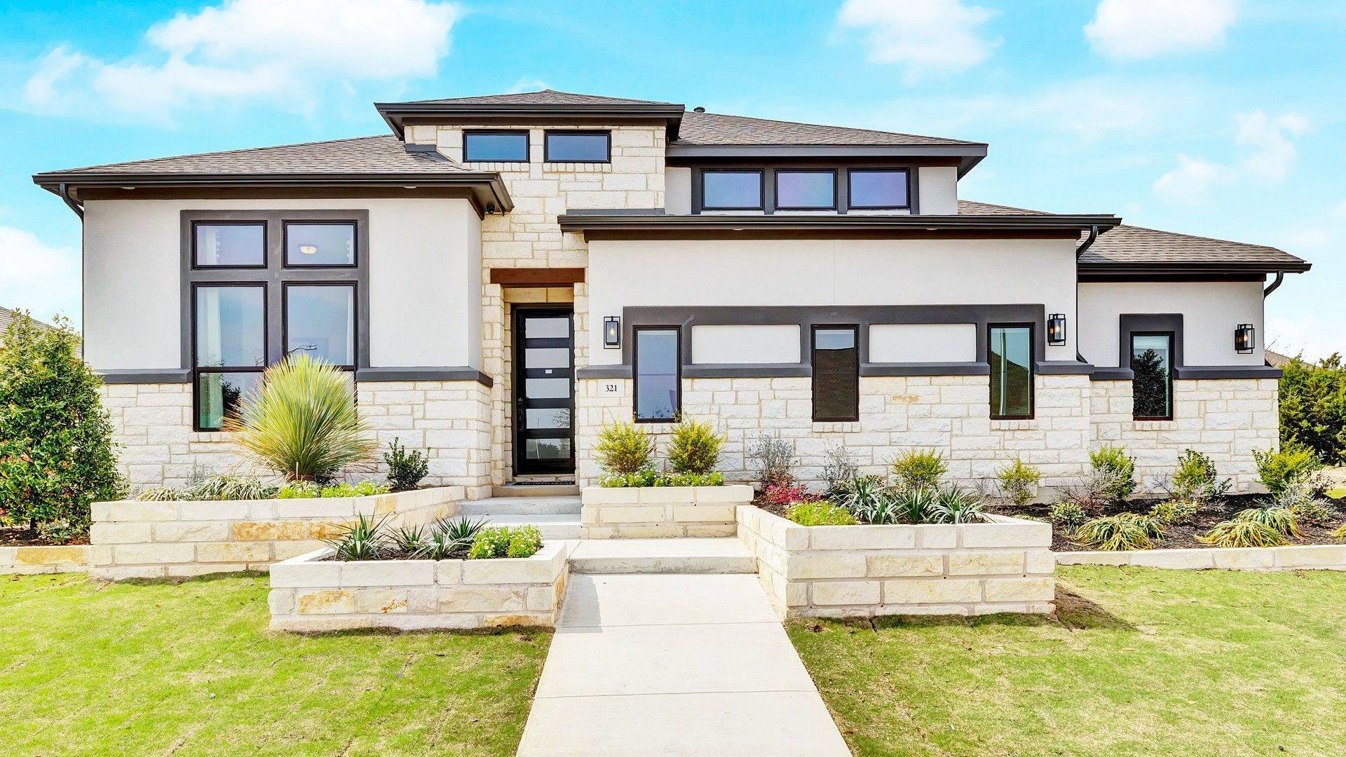 Contemporary Stone and Stucco Home in Hawkes Landing:Elegant stone and stucco facade with expansive windows in Hawkes Landing. Luxurious curb appeal.