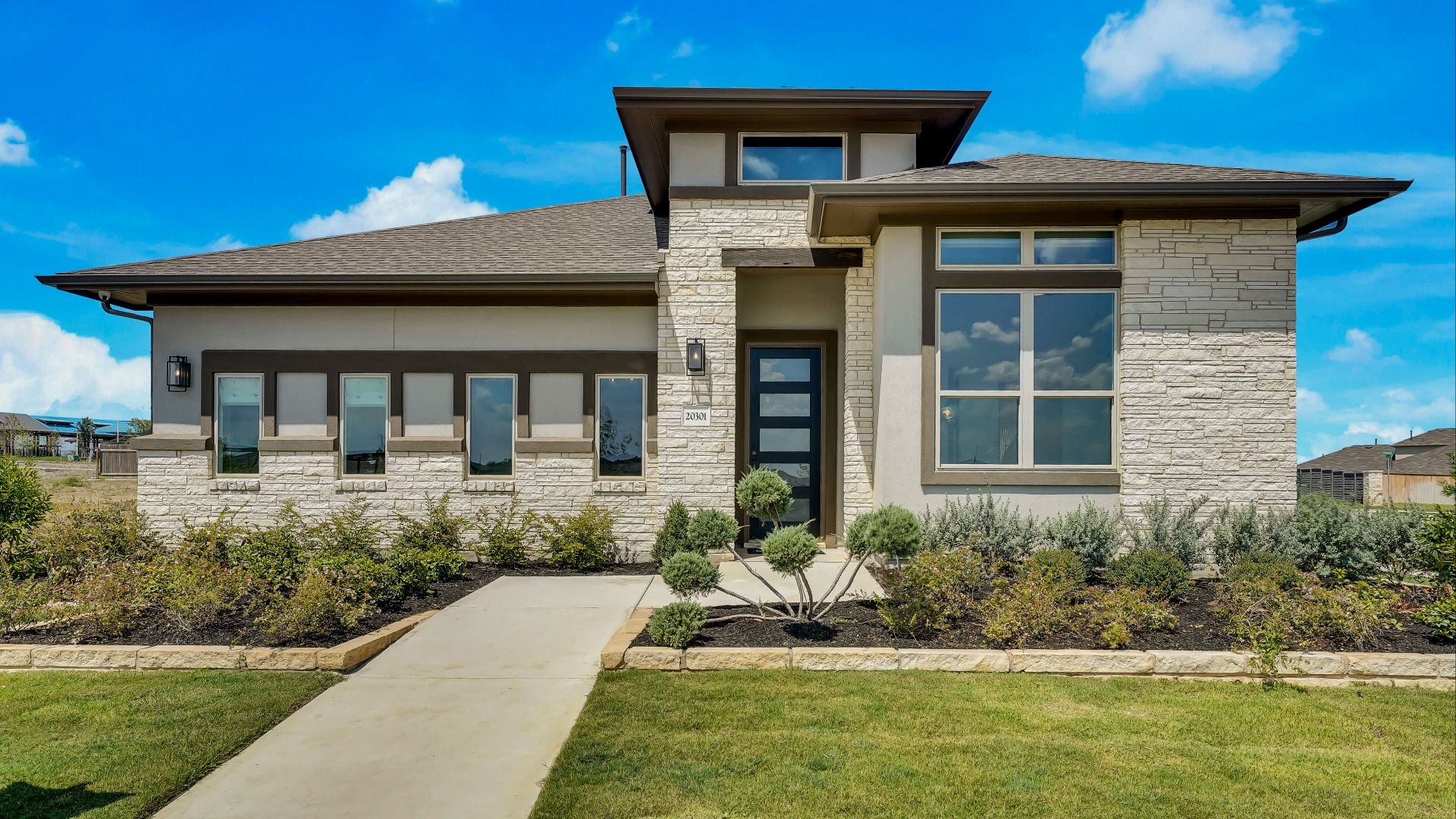 Modern Home in Carillon Community with Brick Façade and Large Windows:Elegant brick facade and expansive windows define this luxurious Carillon community residence.