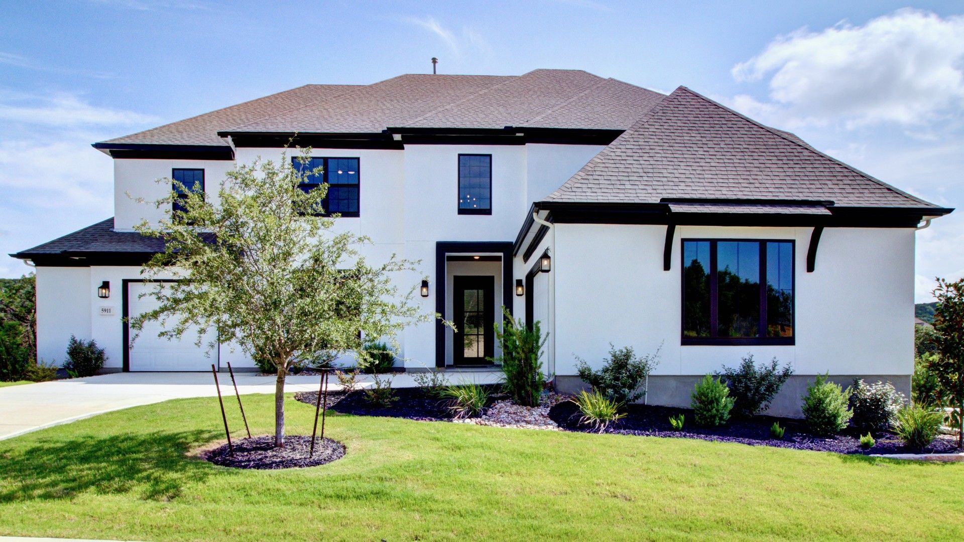 Two-Story Modern House at Verandas at the Rim:Elegant two-story residence features striking gable roof and expansive windows in Verandas at the Rim.