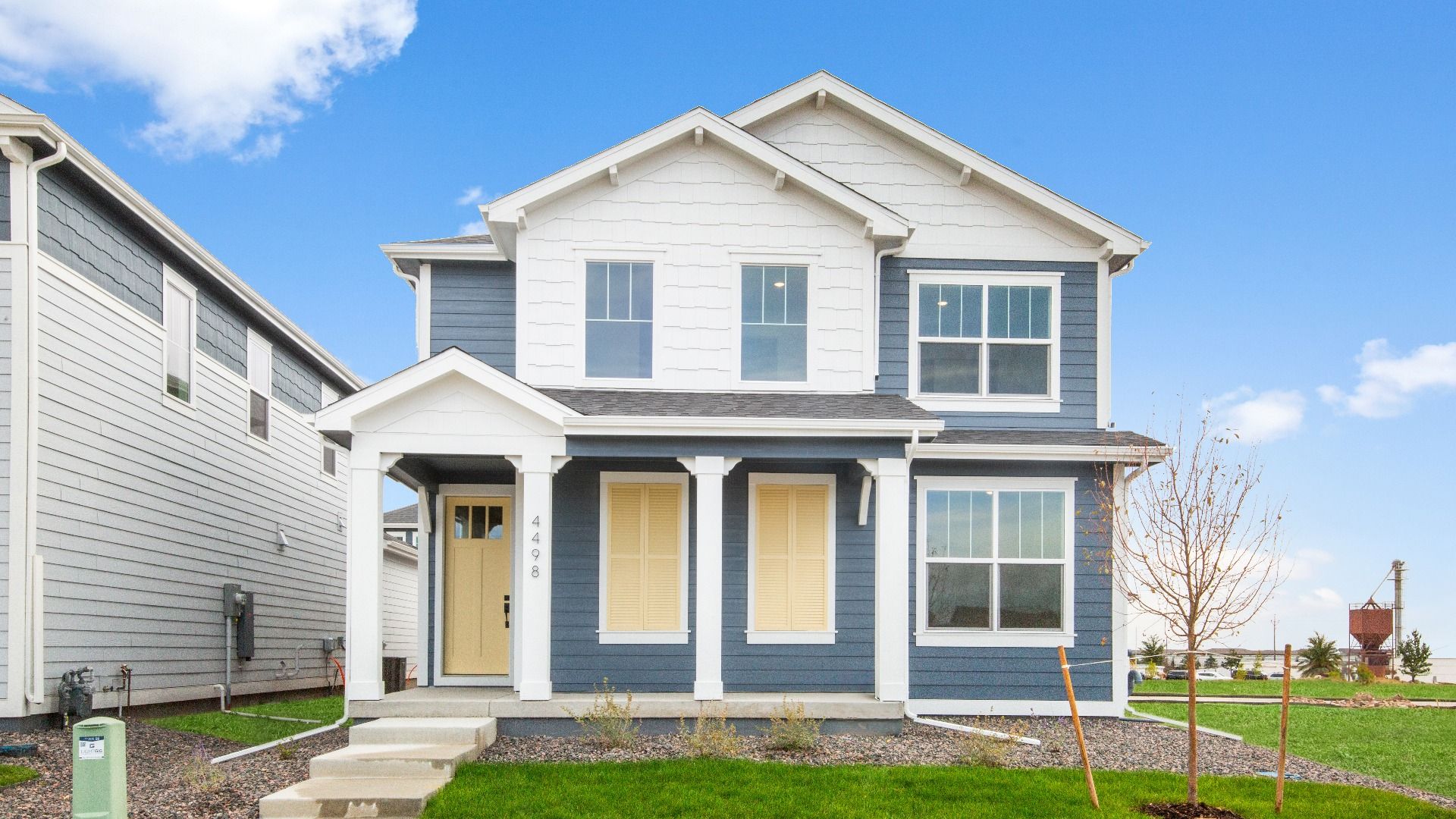 Modern Blue and White House, Timnath Lakes Architecture:Elegant two-story home in Timnath Lakes with contemporary gabled roof and pristine symmetry.
