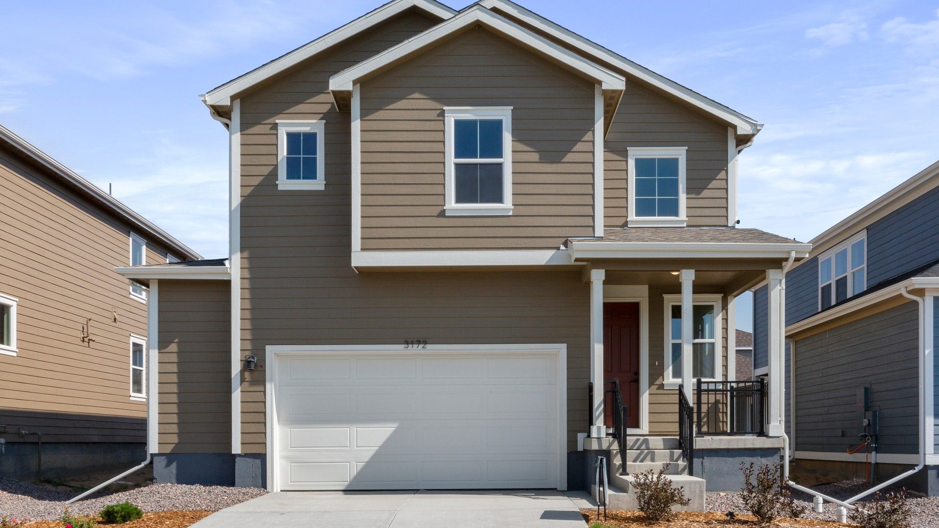 Modern Two-Story Home with Dark Taupe Siding in Lush Suburban Area:Exquisite modern design with pristine dark taupe siding and dark trim accents in lush suburban location.