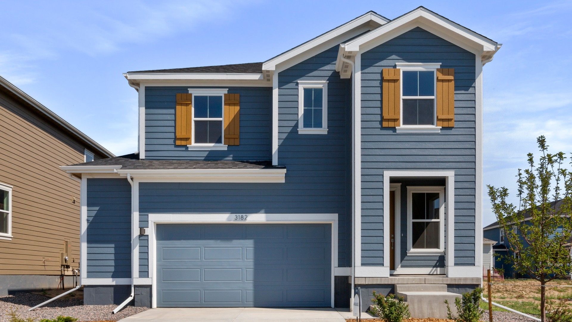 Modern Blue Two-Story Home with Garage in Countryside Setting:Experience luxury in this blue two-story home with elegant white trim and large windows, nestled in serene countryside.